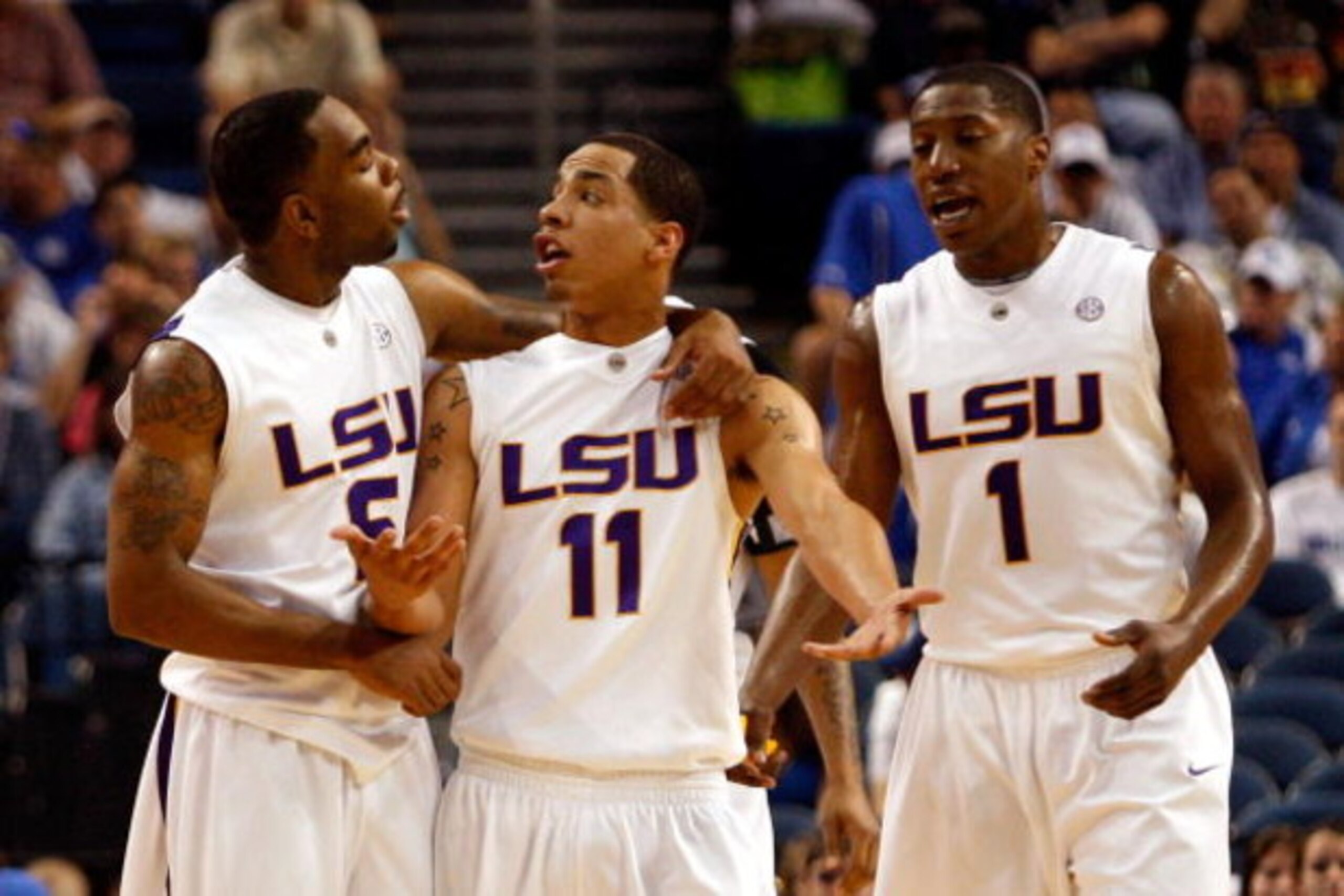 TAMPA, FL - MARCH 13:  Marcus Thornton #5, Bo Spencer #11 and Tasmin Mitchell #1 of the Louisiana State University Tigers talk during a timeout while playing the Kentucky Wildcats during the second round of the SEC Men's Basketball Tournament on March 13,
