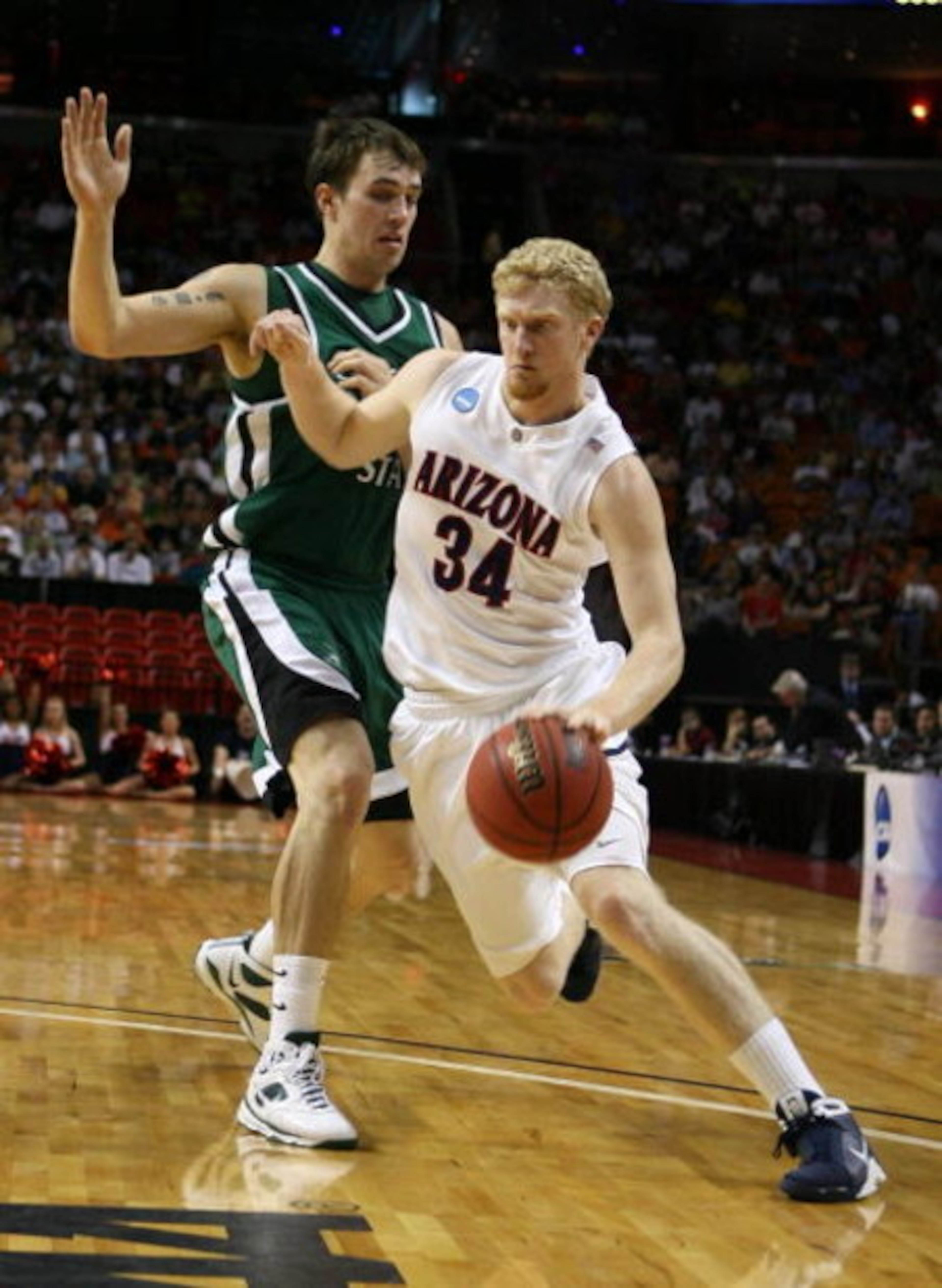 MIAMI - MARCH 22: Forward Chase Budinger #34 of the University of Arizona Wildcats is defended by center Chris Moore #42 of the Cleveland State University Vikings during the second round of the NCAA Division I Men's Basketball Tournament at the American MIAMI - MARCH 22: Forward Chase Budinger #34 of the University of Arizona Wildcats is defended by center Chris Moore #42 of the Cleveland State University Vikings during the second round of the NCAA Division I Men's Basketball Tournament at the American