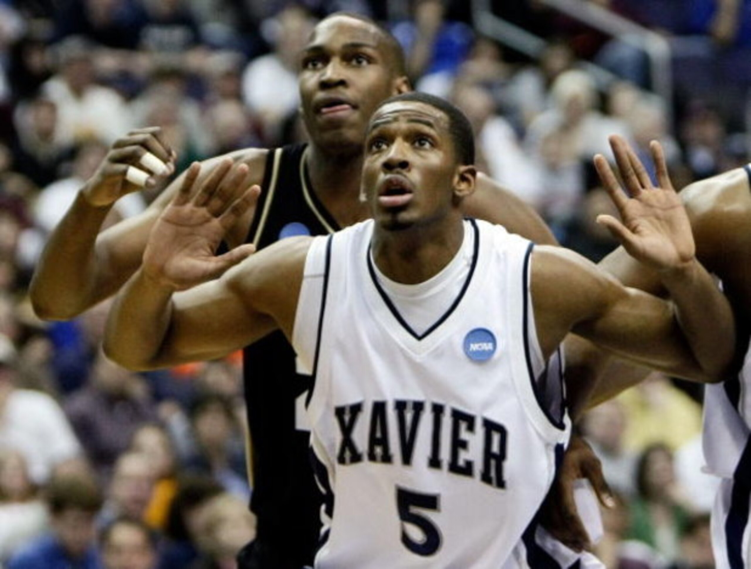 WASHINGTON - MARCH 22:  JaJuan Johnson #25 of the Purdue Boilermakers fights for position against Derrick Brown #5 of the Xavier Musketeers during the second round of the West Regional as part of the 2008 NCAA Men's Basketball Tournament at the Verizon Ce