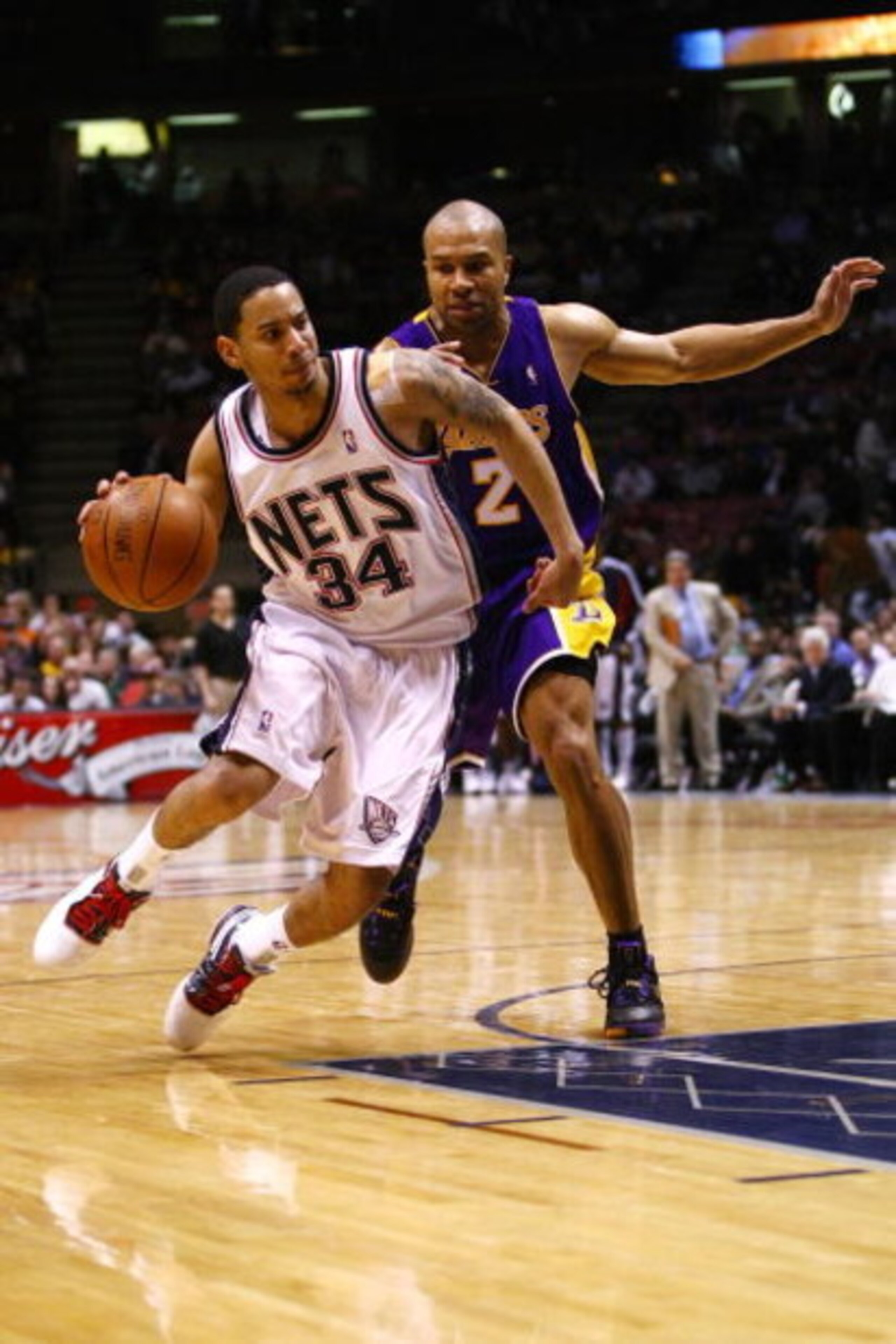 EAST RUTHERFORD, NJ - MARCH 27:  Devin Harris #34 of the New Jersey Nets drives against Derek Fisher #2 of the Los Angeles Lakers during the game on March 27, 2009 at the Izod Center in East Rutherford, New Jersey. NOTE TO USER: User expressly acknowledge