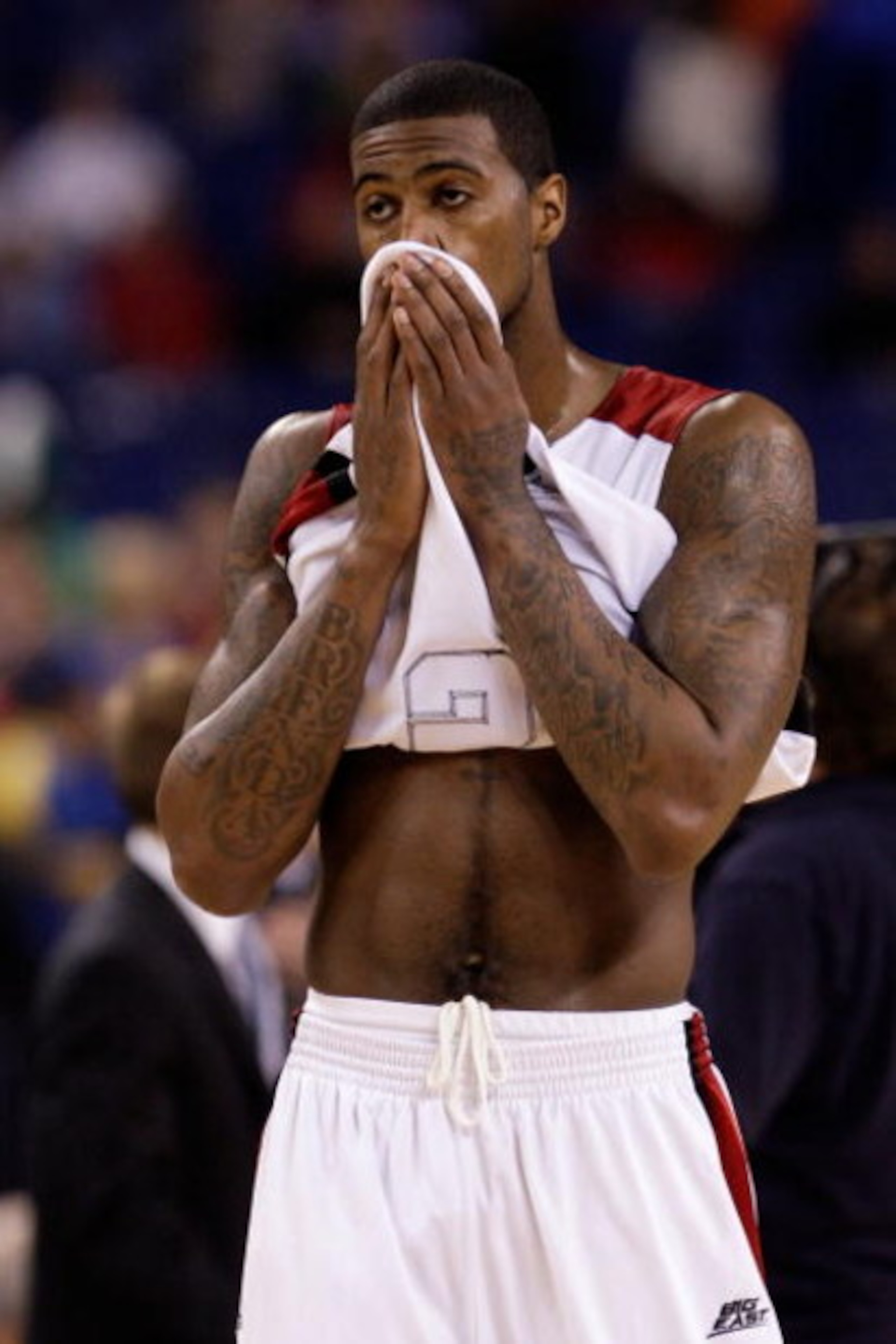 INDIANAPOLIS - MARCH 29:  Earl Clark #5 of the Louisville Cardinals covers his face with his jersey in the final minute of their 64-52 loss against the Michigan State Spartans during the fourth round of the NCAA Division I Men's Basketball Tournament at t
