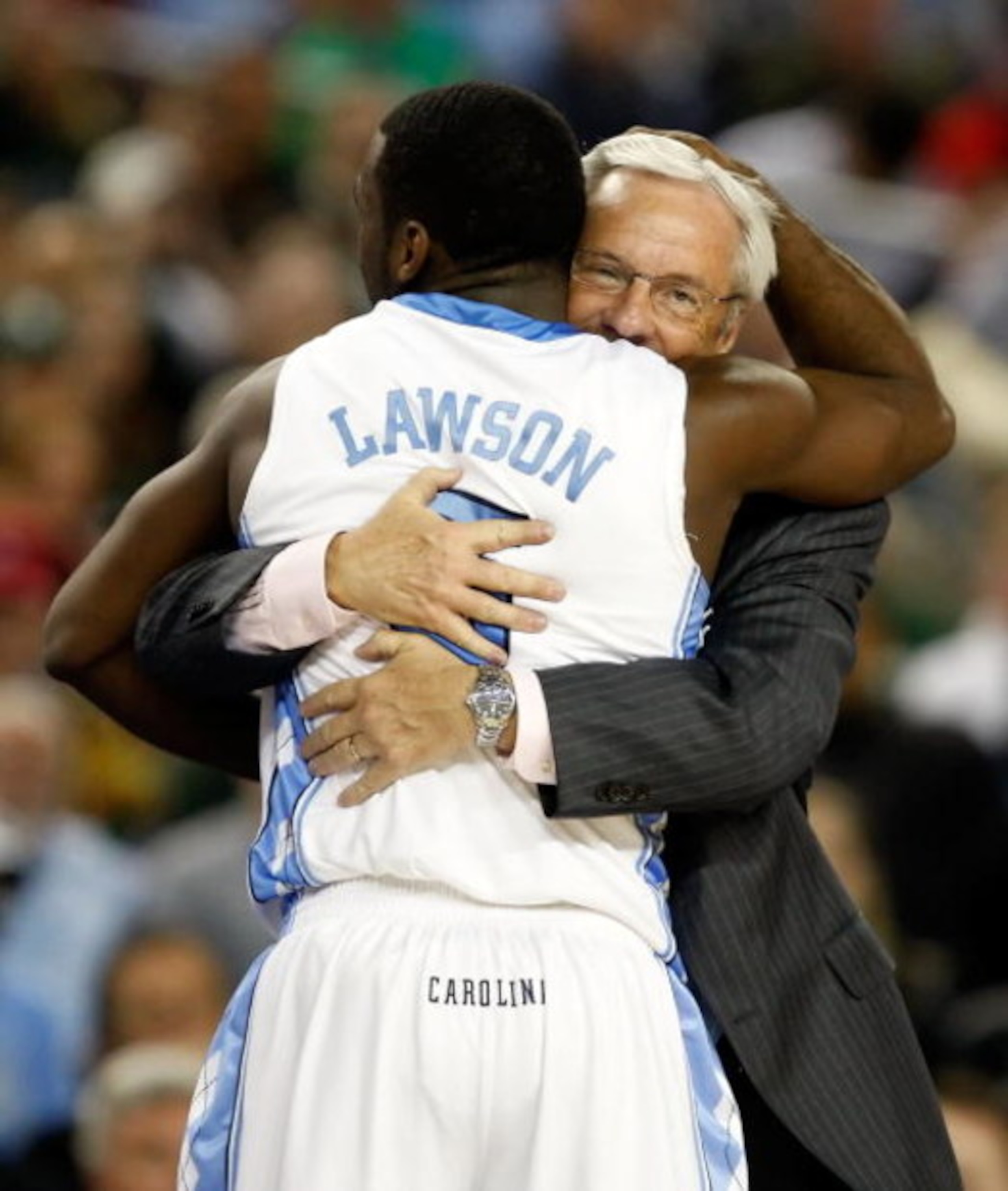 DETROIT - APRIL 06:  Ty Lawson #5 and head coach Roy Williams of the North Carolina Tar Heels hug as Lawson exits the game late in the second half against the Michigan State Spartans during the 2009 NCAA Division I Men's Basketball National Championship g