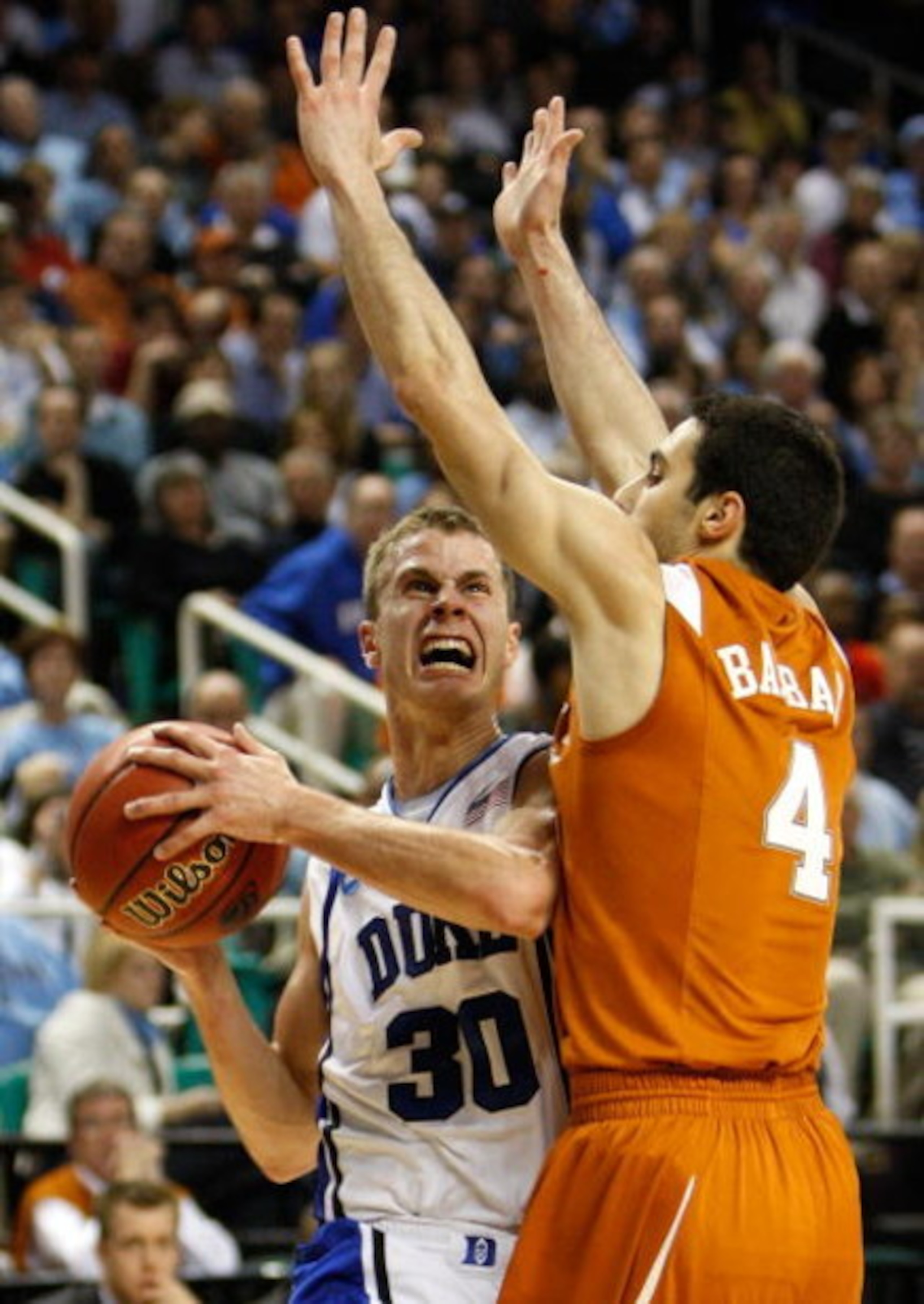 GREENSBORO, NC - MARCH 21:  Jon Scheyer #30 of the Duke Blue Devils drives against Dogus Balbay #4 of the Texas Longhorns during the second round of the NCAA Division I Men's Basketball Tournament at the Greensboro Coliseum on March 21, 2009 in Greensboro