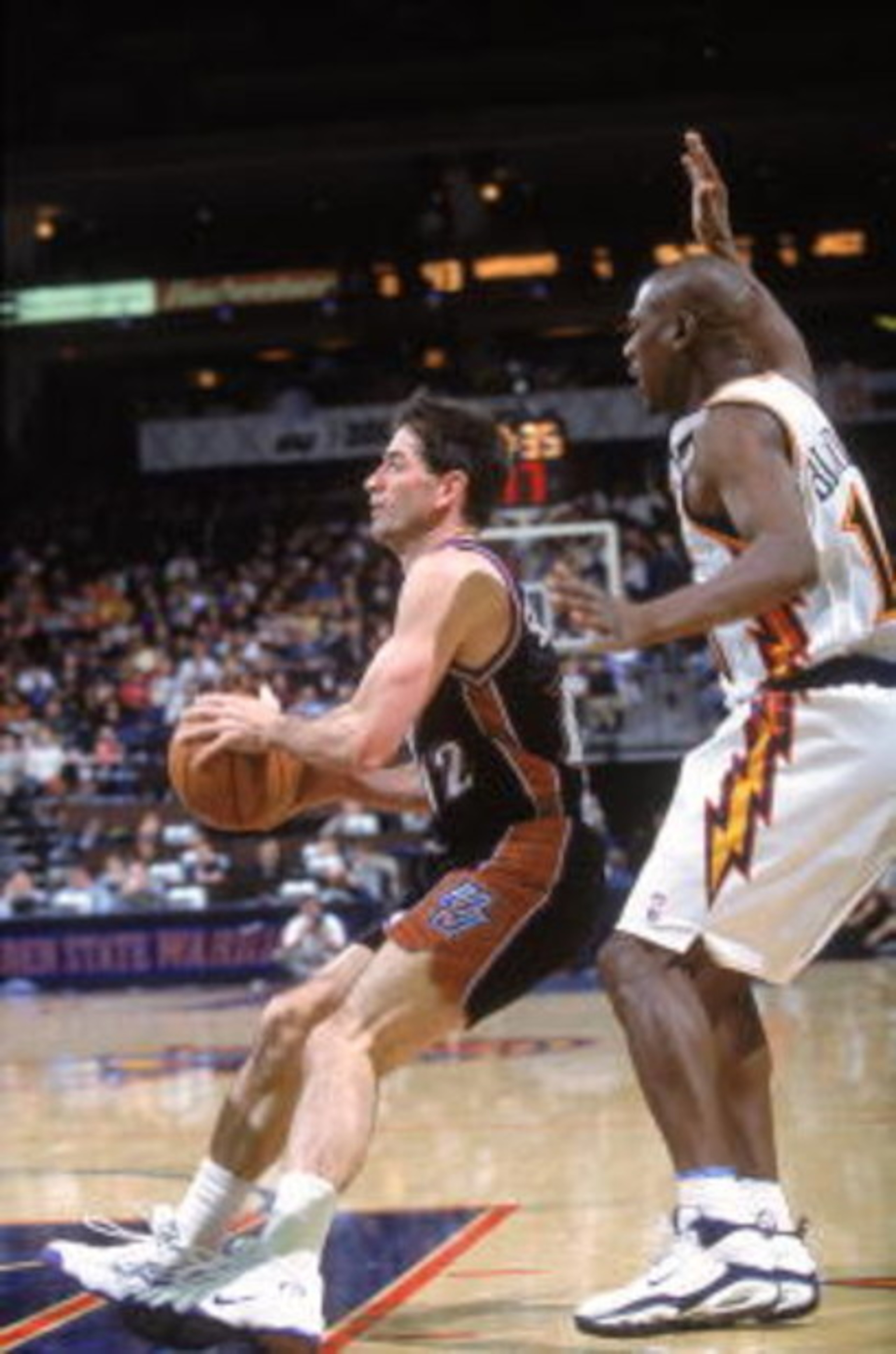 29 Dec 2000:  John Stockton #12 of the Utah Jazz slides with the ball as he is guarded by Mookie Blaylock #10 of the Golden State Warriors at The Arena of Oakland in California.  The Warriors defeated the Jazz 100-89.    NOTE TO USER: It is expressly unde