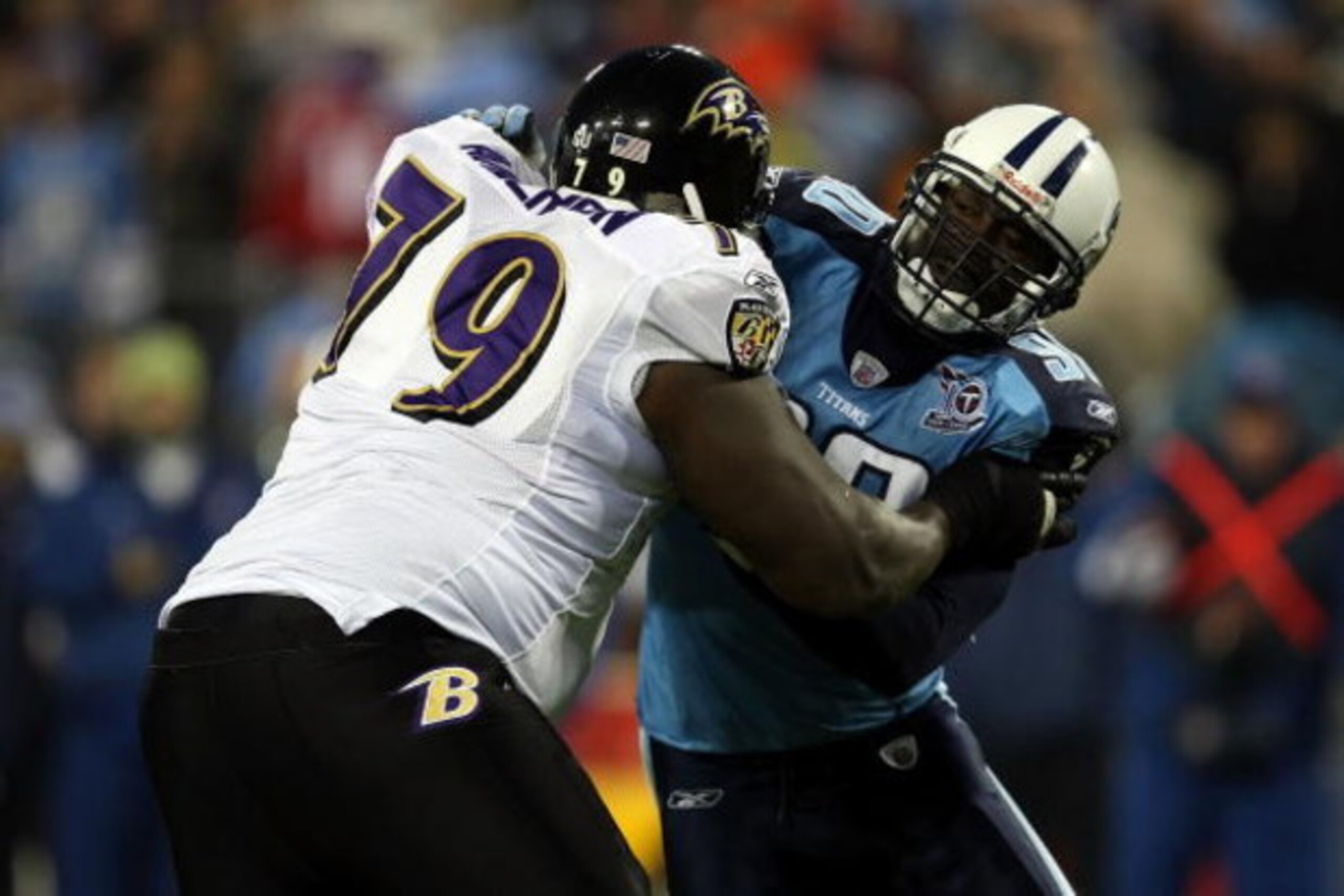 NASHVILLE, TN - JANUARY 10:  Defensive end Jevon Kearse #90 of the Tennessee Titans is blocked by tackle Willie Anderson #79 of the Baltimore Ravens during the AFC Divisional Playoff Game on January 10, 2009 at LP Field in Nashville, Tennessee.  (Photo by