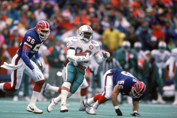 ORCHARD PARK, NY - DECEMBER 23:  Wide receiver Mark Clayton #83 of the Miami Dolphins runs with the ball against the Buffalo Bills during a game at Ralph Wilson Stadium on December 23, 1990 in Orchard Park, New York.  The Bills won 24-17.  (Photo by Rick 
