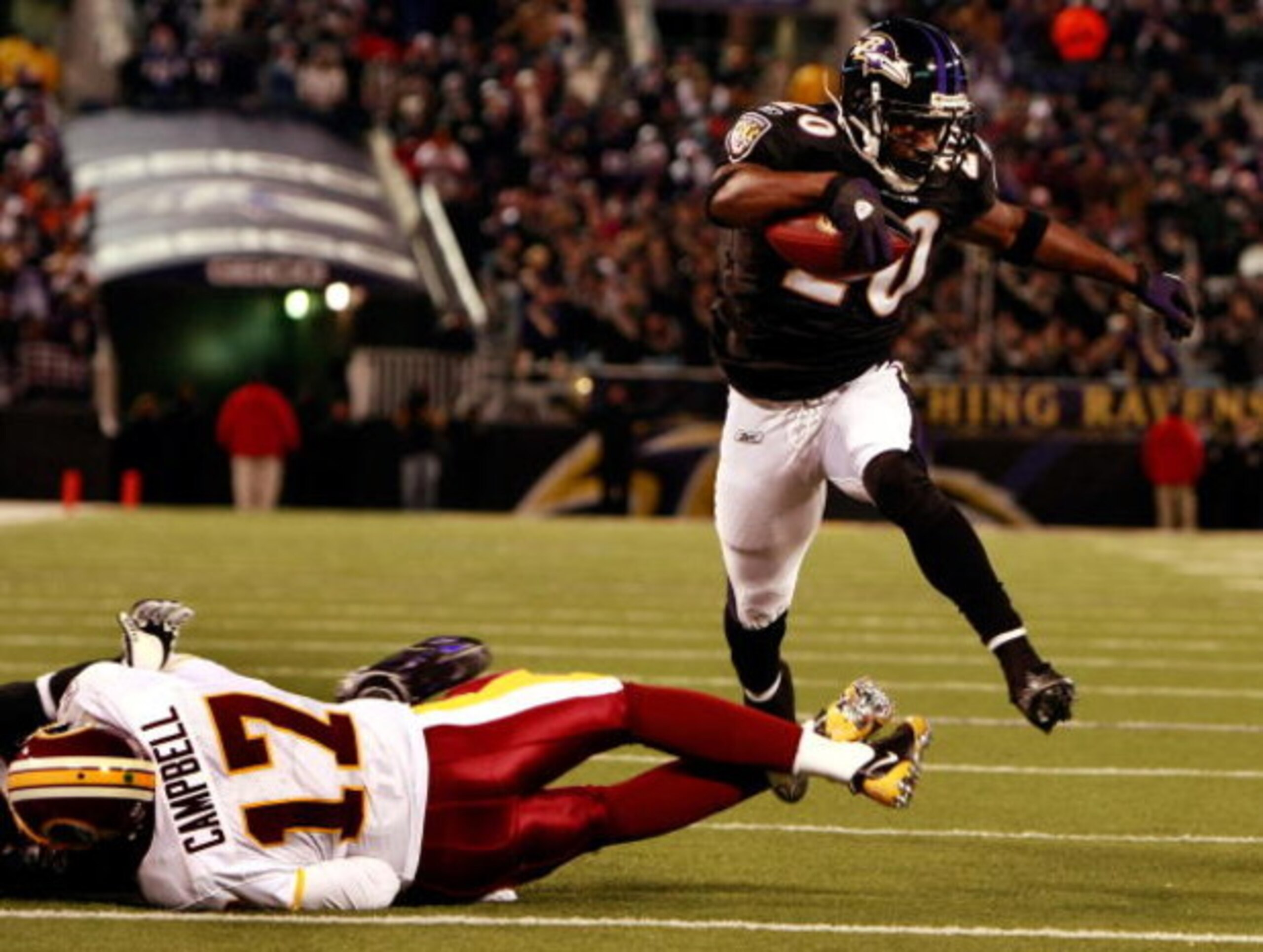 BALTIMORE - DECEMBER 07:  Safety Ed Reed #20 of the Baltimore Ravens returns a fumble for a touchdown as he leaps over quarterback Jason Campbell #17 of the Washington Redskins December 7, 2008 at M&T Bank Stadium in Baltimore, Maryland.  (Photo by Win Mc