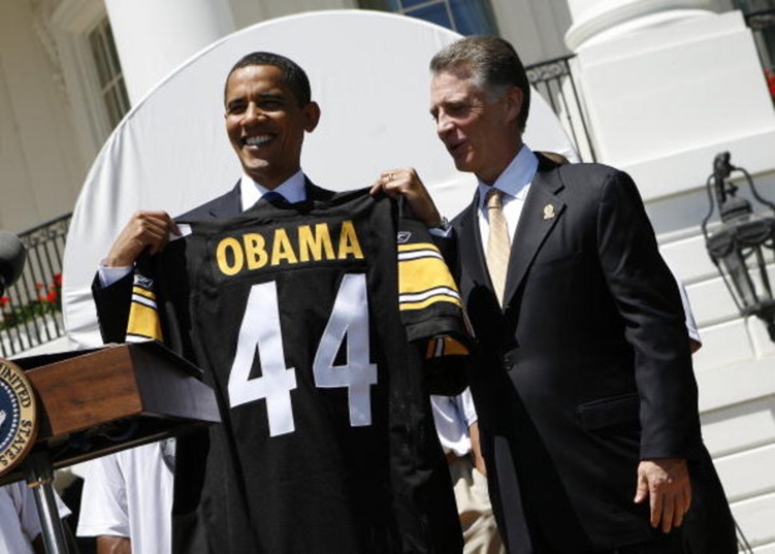 WASHINGTON  - MAY 21:  U.S. President Barack Obama (L) holds up a jersey as Pittsburgh Steelers as President Art Rooney II (3rd R), looks on at the South Portico of White House May 21, 2009 in Washington, DC. The Steelers deafeated the Arizona Cardinals i