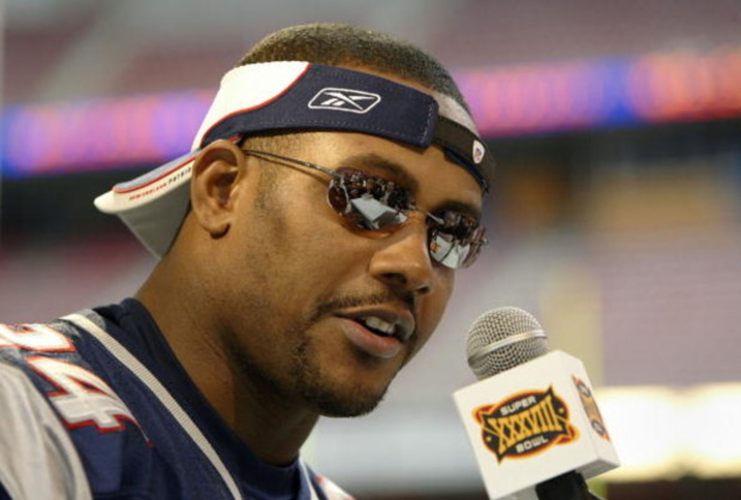 HOUSTON - JANUARY 27:  Cornerback Ty Law #24 of the New England Patriots answers questions on media day January 27, 2003 at Reliant Stadium before Super Bowl XXXVIII against the Carolina Panthers in Houston, Texas.  (Photo by Brian Bahr/Getty Images)
