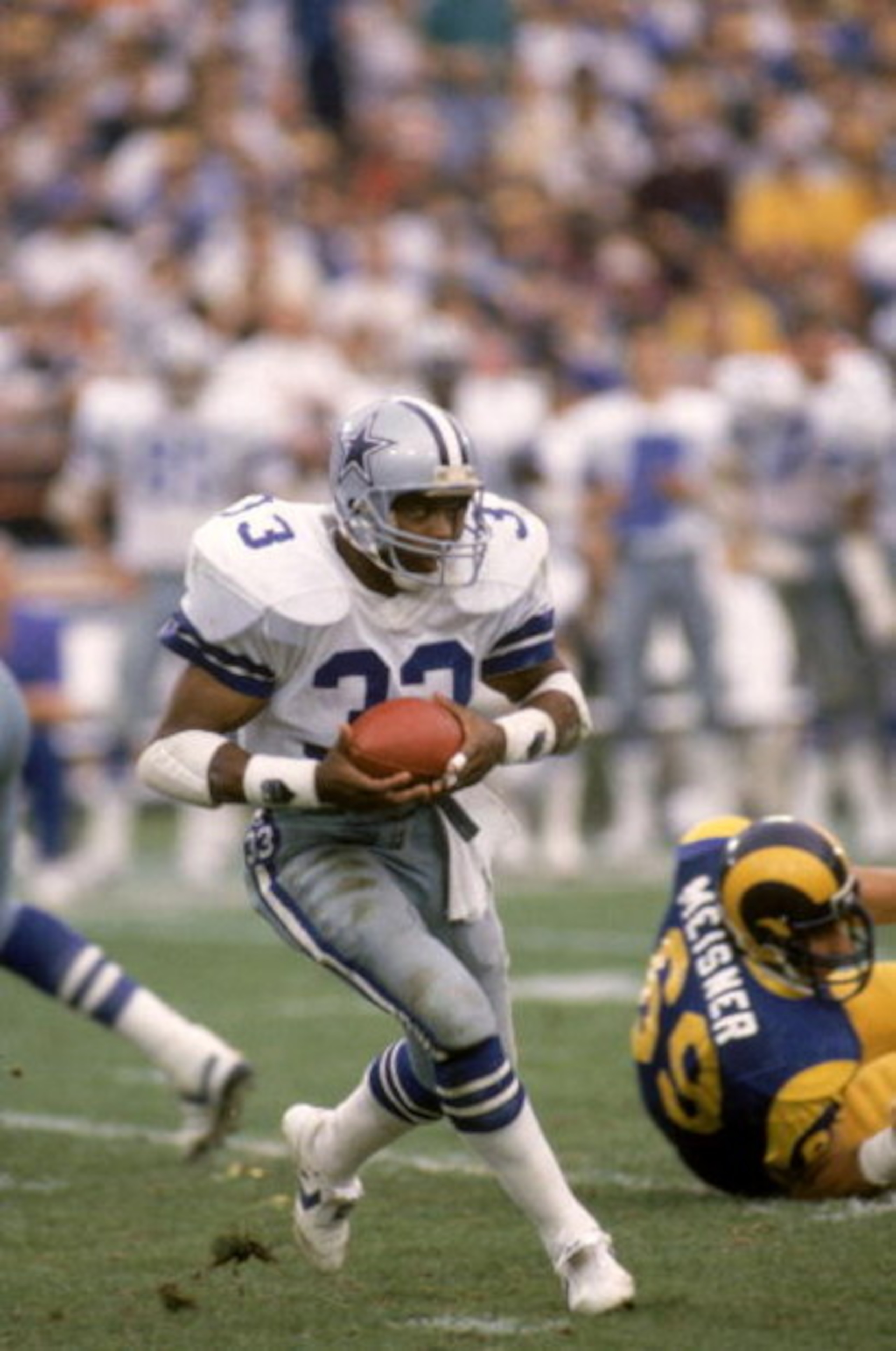 ANAHEIM, CA - JANUARY 4:  Running back Tony Dorsett #33 of the Dallas Cowboys rushes for yards during a 1985 NFC Divisional Playoff game against the Los Angeles Rams at Anaheim Stadium on January 4, 1996 in Anaheim, California.  The Rams won 20-0.  (Photo