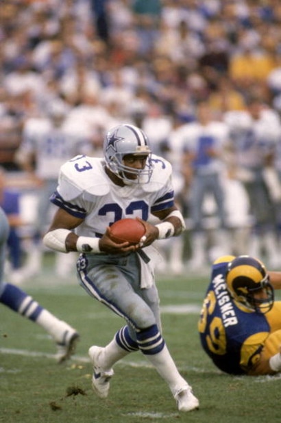 ANAHEIM, CA - JANUARY 4:  Running back Tony Dorsett #33 of the Dallas Cowboys rushes for yards during a 1985 NFC Divisional Playoff game against the Los Angeles Rams at Anaheim Stadium on January 4, 1996 in Anaheim, California.  The Rams won 20-0.  (Photo