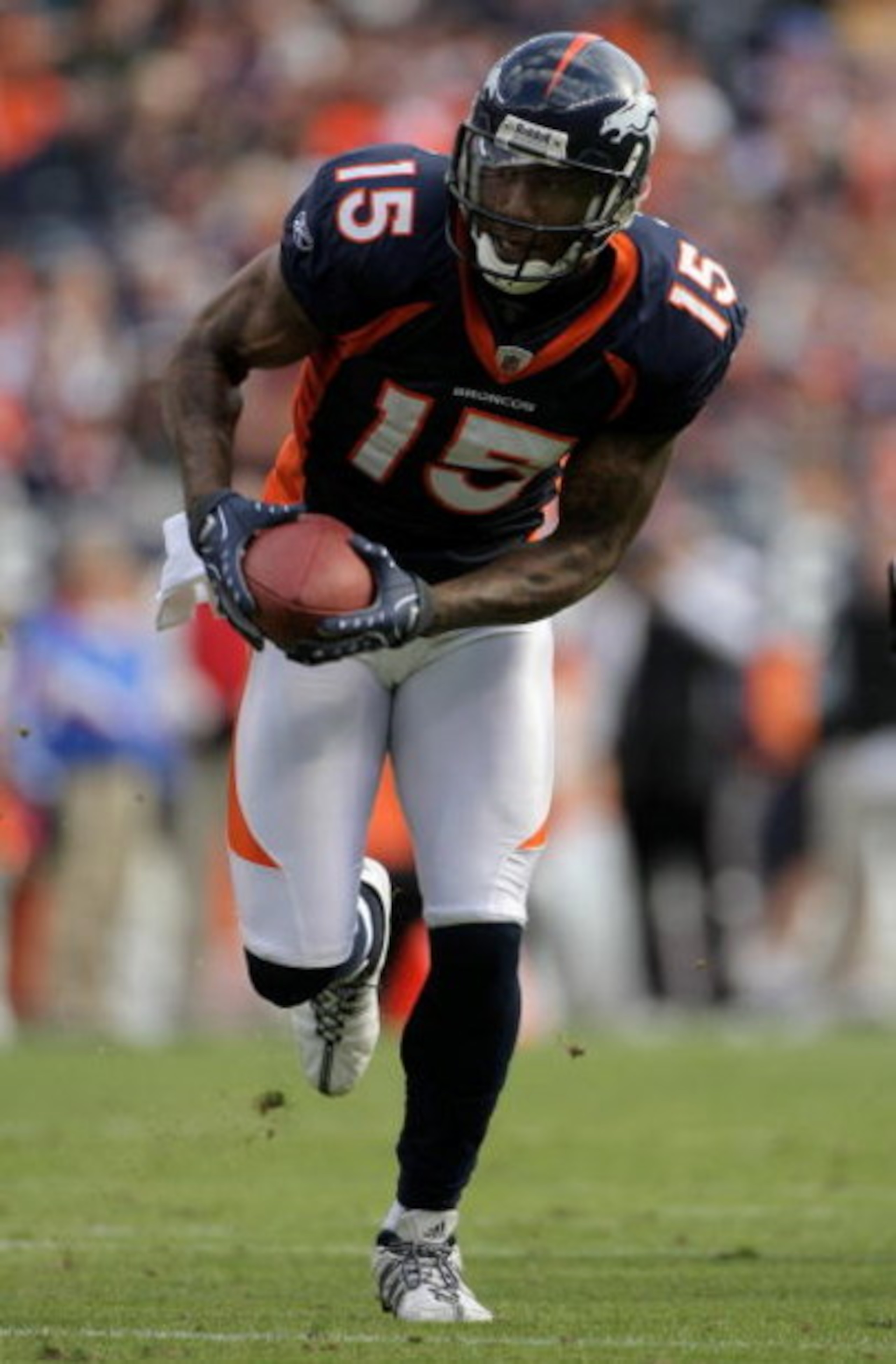 DENVER - NOVEMBER 23:  Wide receiver Brandon Marshall #15 of the Denver Broncos makes a reception against the Oakland Raiders during week 12 NFL action at Invesco Field at Mile High on November 23, 2008 in Denver, Colorado. The Raiders defeated the Bronco