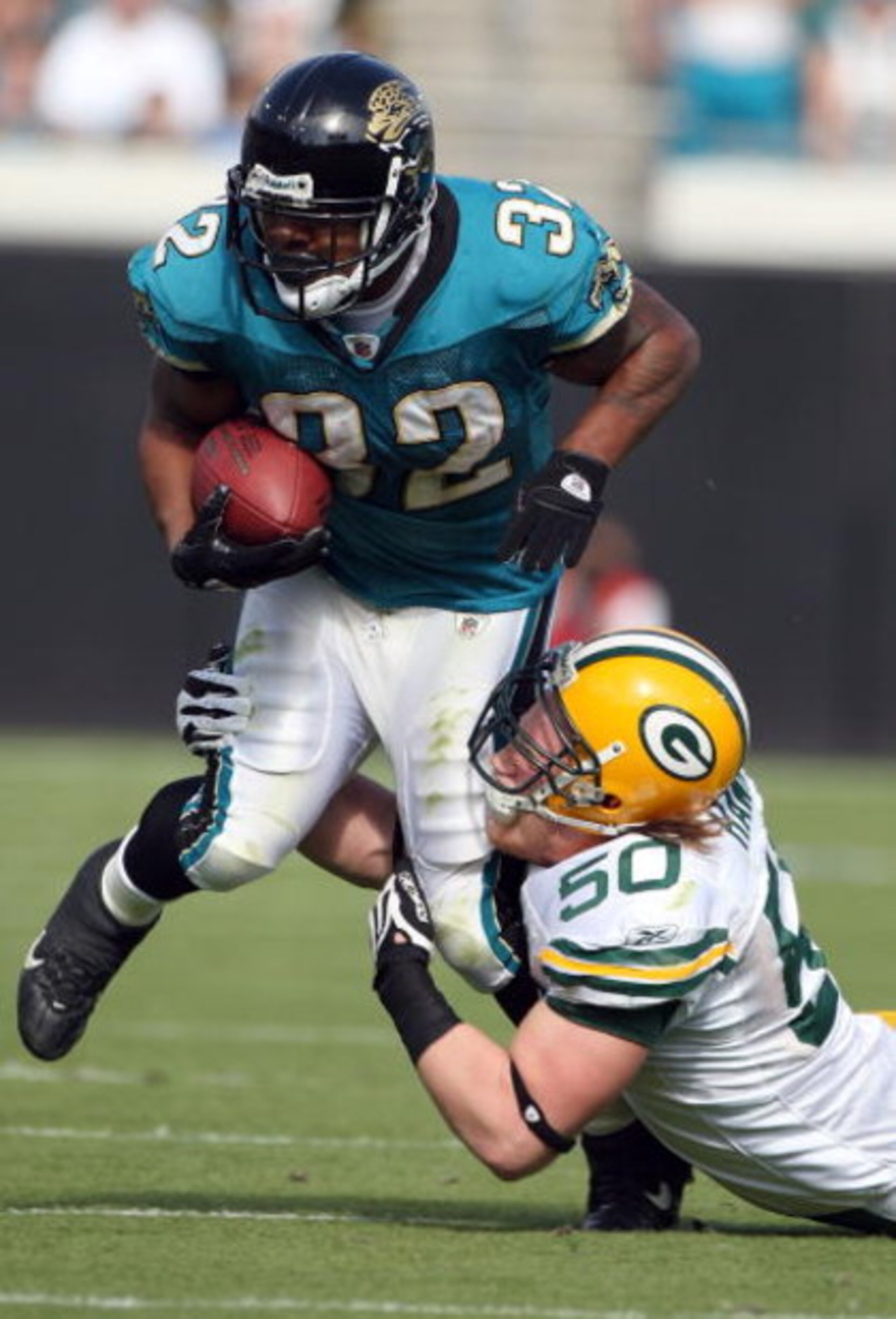 JACKSONVILLE, FL - DECEMBER 14:  A. J. Hawk #50 of the Green Bay Packers attempts to tackle Maurice Jones-Drew #32 of the Jacksonville Jaguars during the game at Jacksonville Municipal stadium on December 14, 2008 in Jacksonville, Florida.  (Photo by Sam 