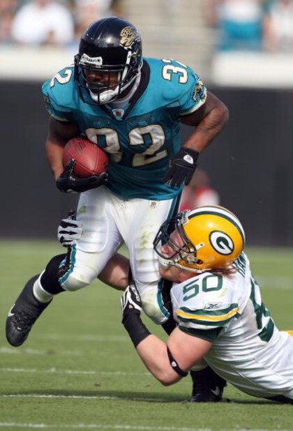 JACKSONVILLE, FL - DECEMBER 14:  A. J. Hawk #50 of the Green Bay Packers attempts to tackle Maurice Jones-Drew #32 of the Jacksonville Jaguars during the game at Jacksonville Municipal stadium on December 14, 2008 in Jacksonville, Florida.  (Photo by Sam 