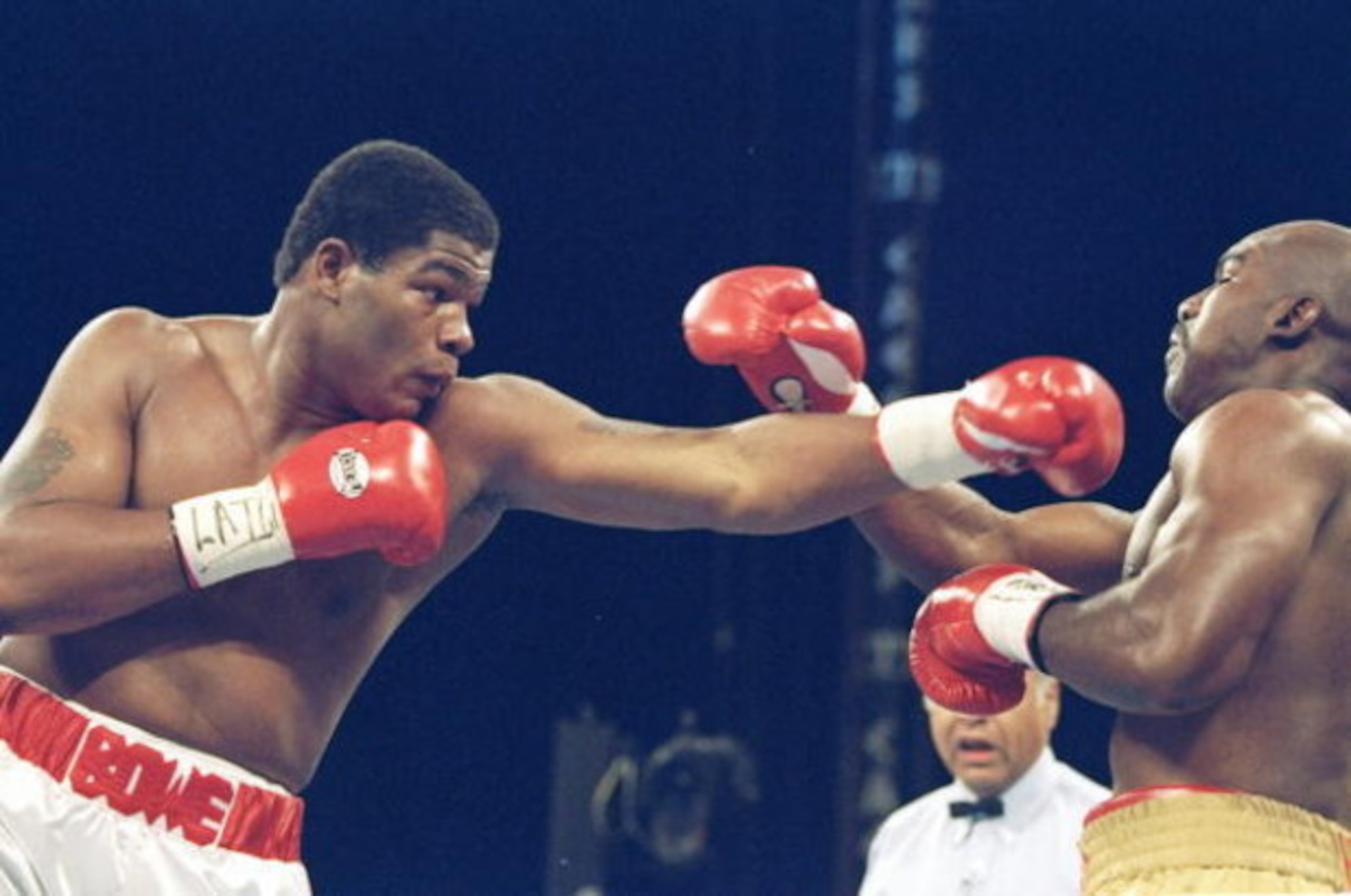 4 Nov 1995:  Riddick Bowe (left) lands a left blow on Evander Holyfield III during a bout at the Caesar Palace in Las Vegas, Nevada.  Riddick Bowe won the fight with a technical knockout in the eigth round.. Mandatory Credit: Al Bello  /Allsport