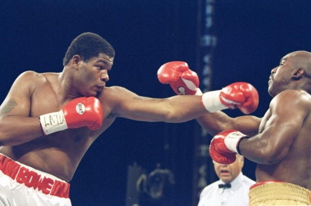 4 Nov 1995:  Riddick Bowe (left) lands a left blow on Evander Holyfield III during a bout at the Caesar Palace in Las Vegas, Nevada.  Riddick Bowe won the fight with a technical knockout in the eigth round.. Mandatory Credit: Al Bello  /Allsport