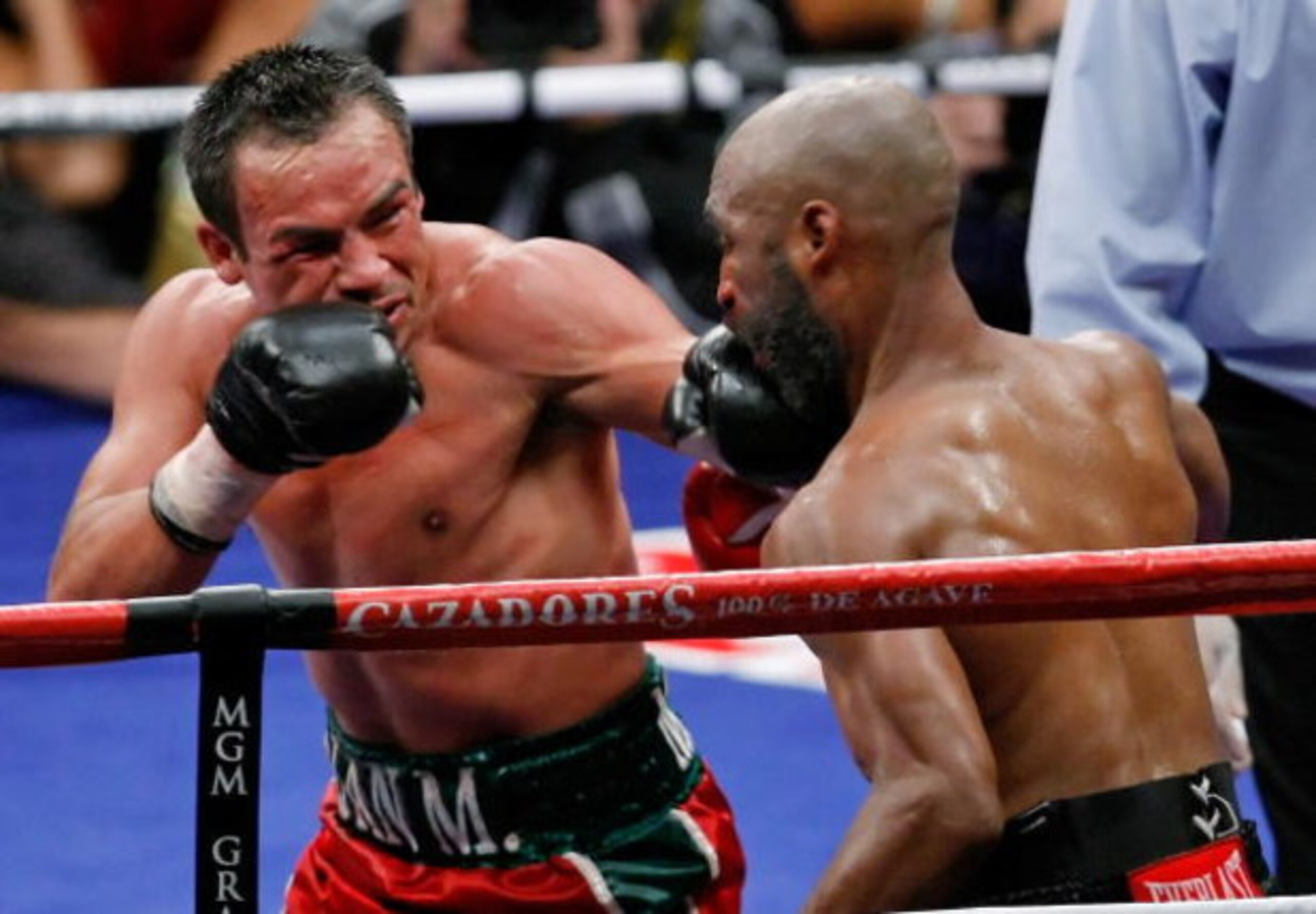 LAS VEGAS - SEPTEMBER 13:  Juan Manuel Marquez (L) hits Joel Casamayor in the 11th round of their bout at the MGM Grand Garden Arena September 13, 2008 in Las Vegas, Nevada. Marquez won by knockout in the 11th round.  (Photo by Ethan Miller/Getty Images)
