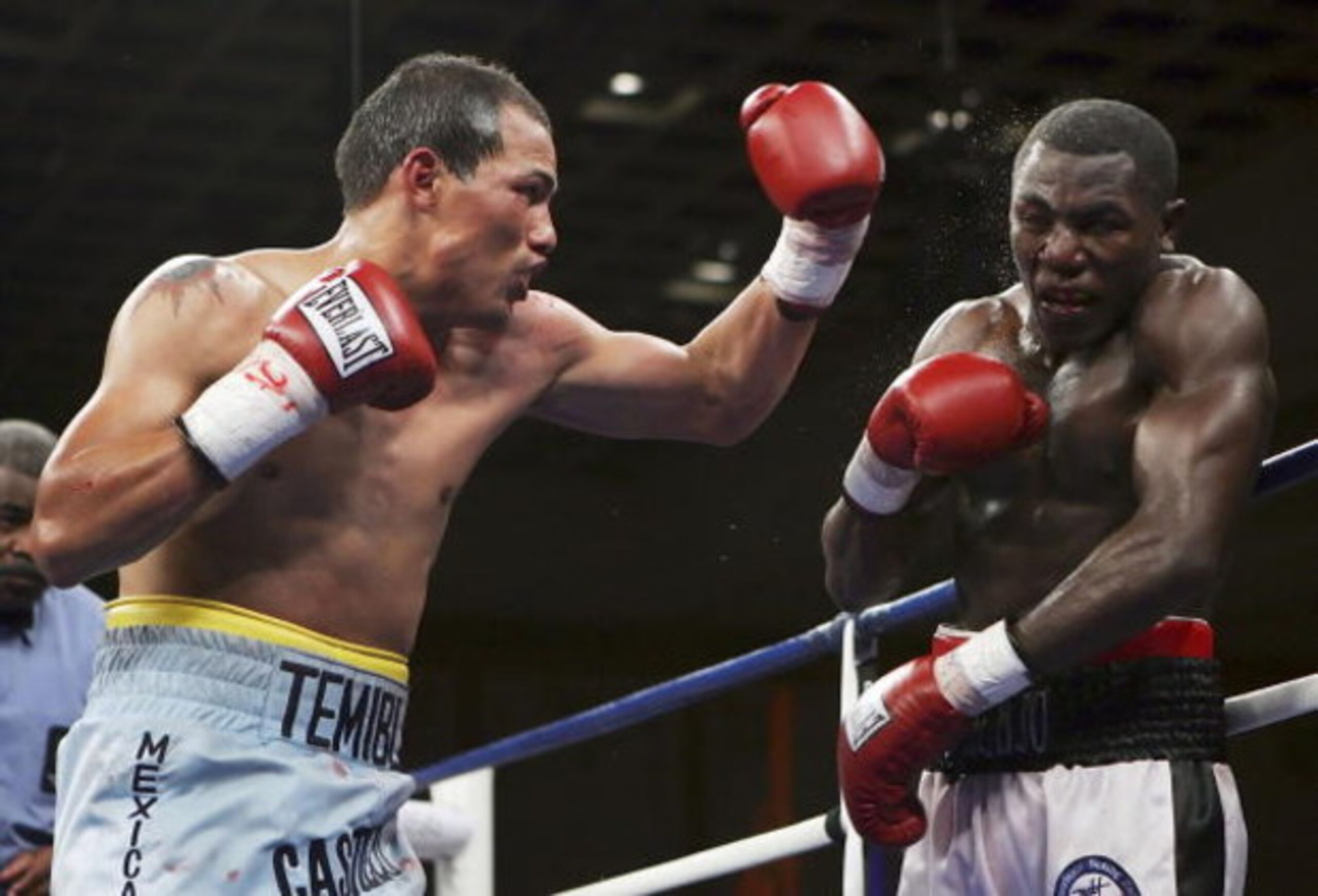 LAS VEGAS - JANUARY 20:  Jose Luis Castillo (L) of Mexico throws a left to the face of Herman Ngoudjo of Canada during their super lightweight title eliminator fight on January 20, 2007 in the Paris Ballroom at the Paris Hotel in Las Vegas, Nevada. Castil