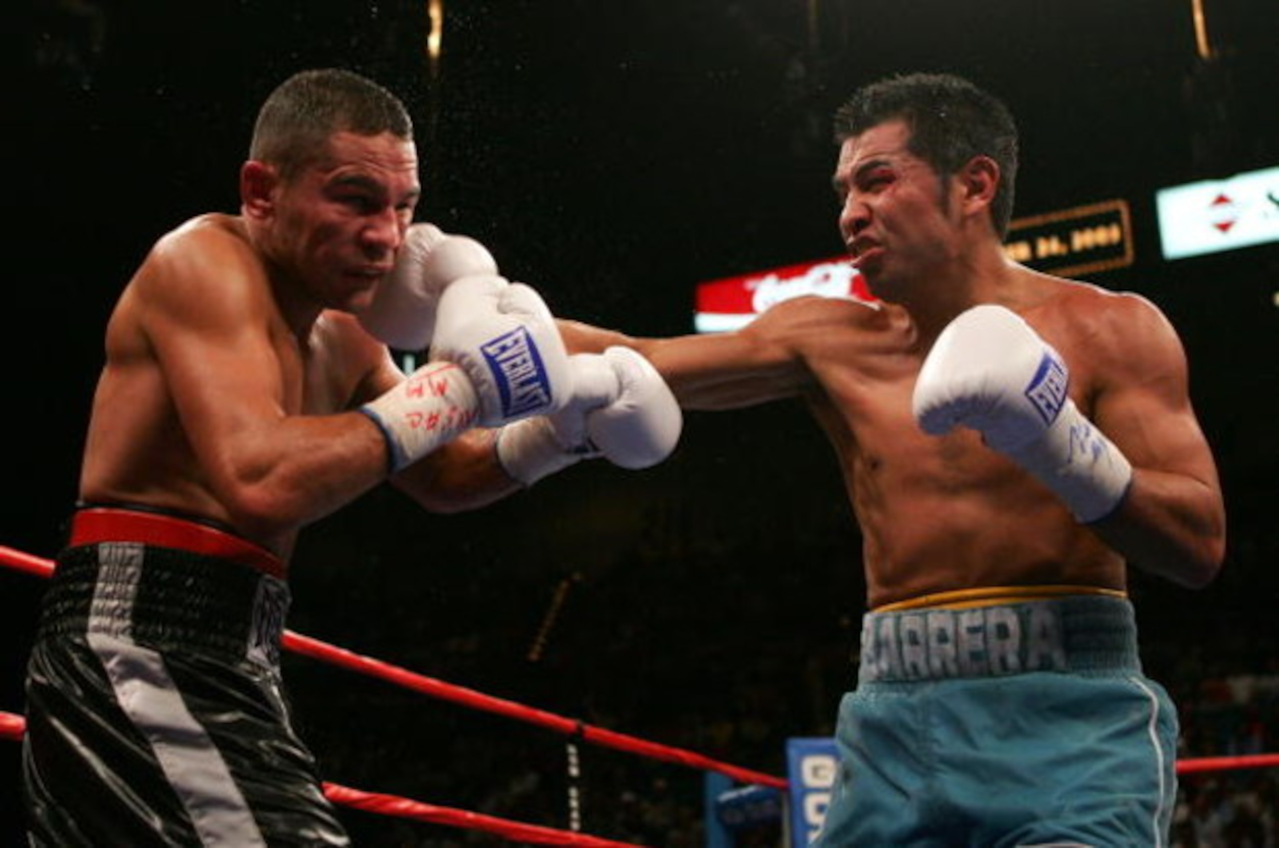 LAS VEGAS - SEPTEMBER 17:  Marco Antonio Barrera (R) lands a right against Robbie Peden as he gets knocked back in the WBC-IBF Unification Super Featherweight World Title fight at the MGM Grand Garden Arena on September 17, 2005 in Las Vegas, Nevada. Barr