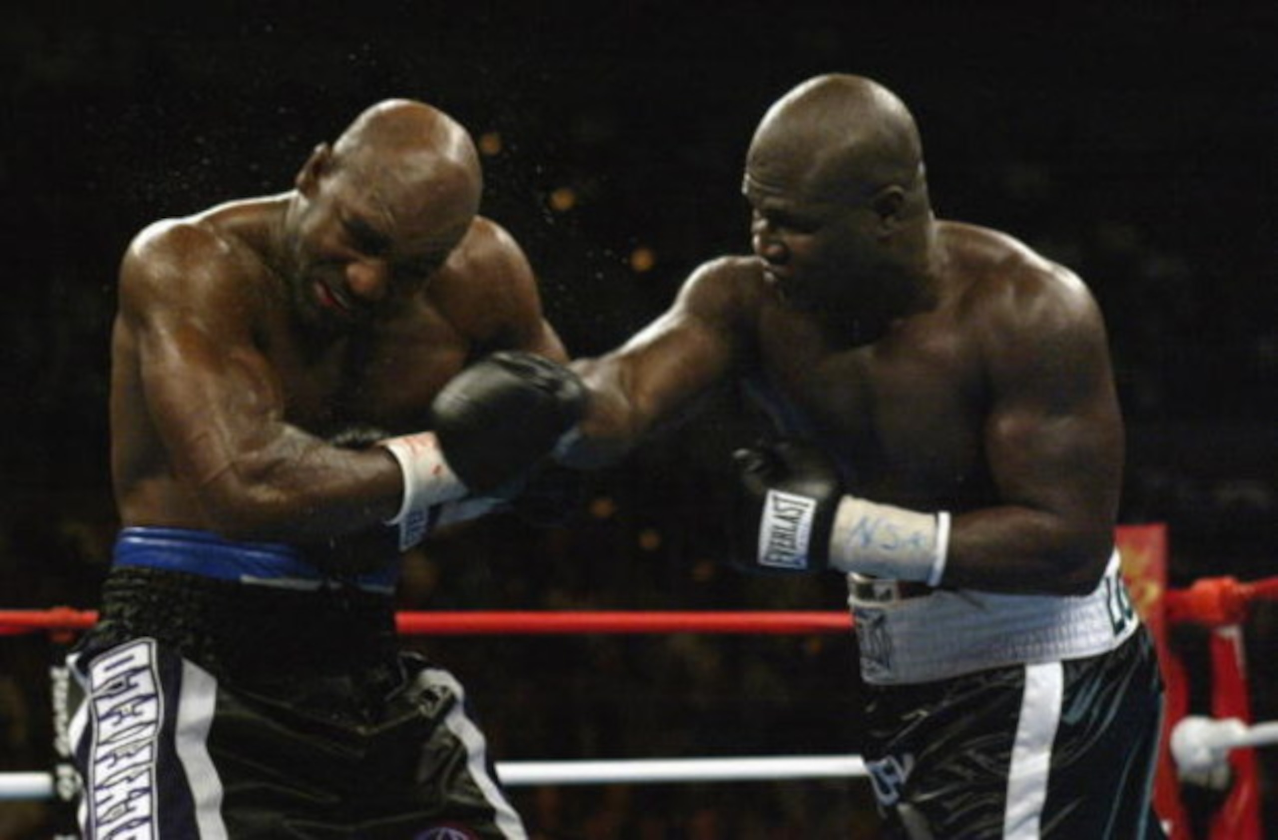 LAS VEGAS - OCTOBER 4:  Evander Holyfield (L) is hit by James Toney in a heavyweight fight on October 4, 2003 at the Mandalay Bay Casino in Las Vegas, Nevada.  Toney defeated Holyfield by TKO in the ninth round.  (Photo by Jed Jacobsohn/Getty Images)