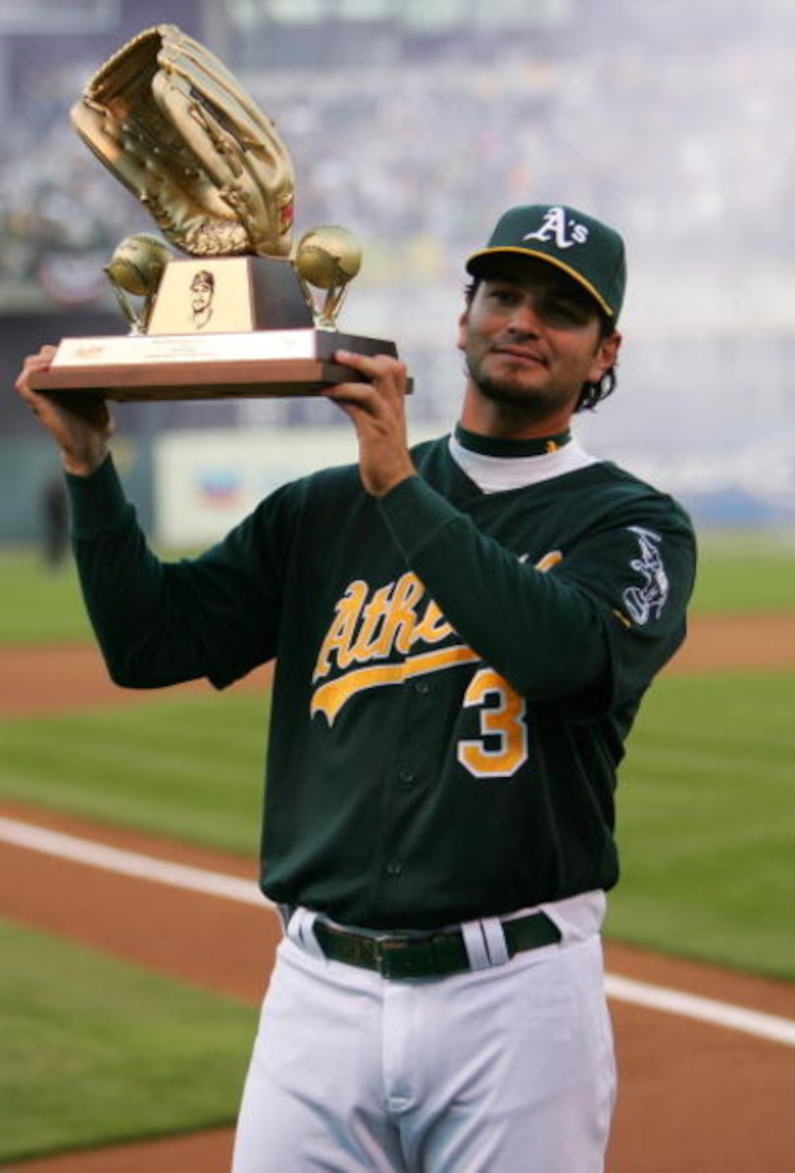 OAKLAND, CA - APRIL 9:  Eric Chavez #3 of the Oakland Athletics holds up his sixth career Gold Glove Award before his game against the Chicago White Sox at McAfee Coliseum April 9, 2007 in Oakland, California.  (Photo by Jed Jacobsohn/Getty Images)