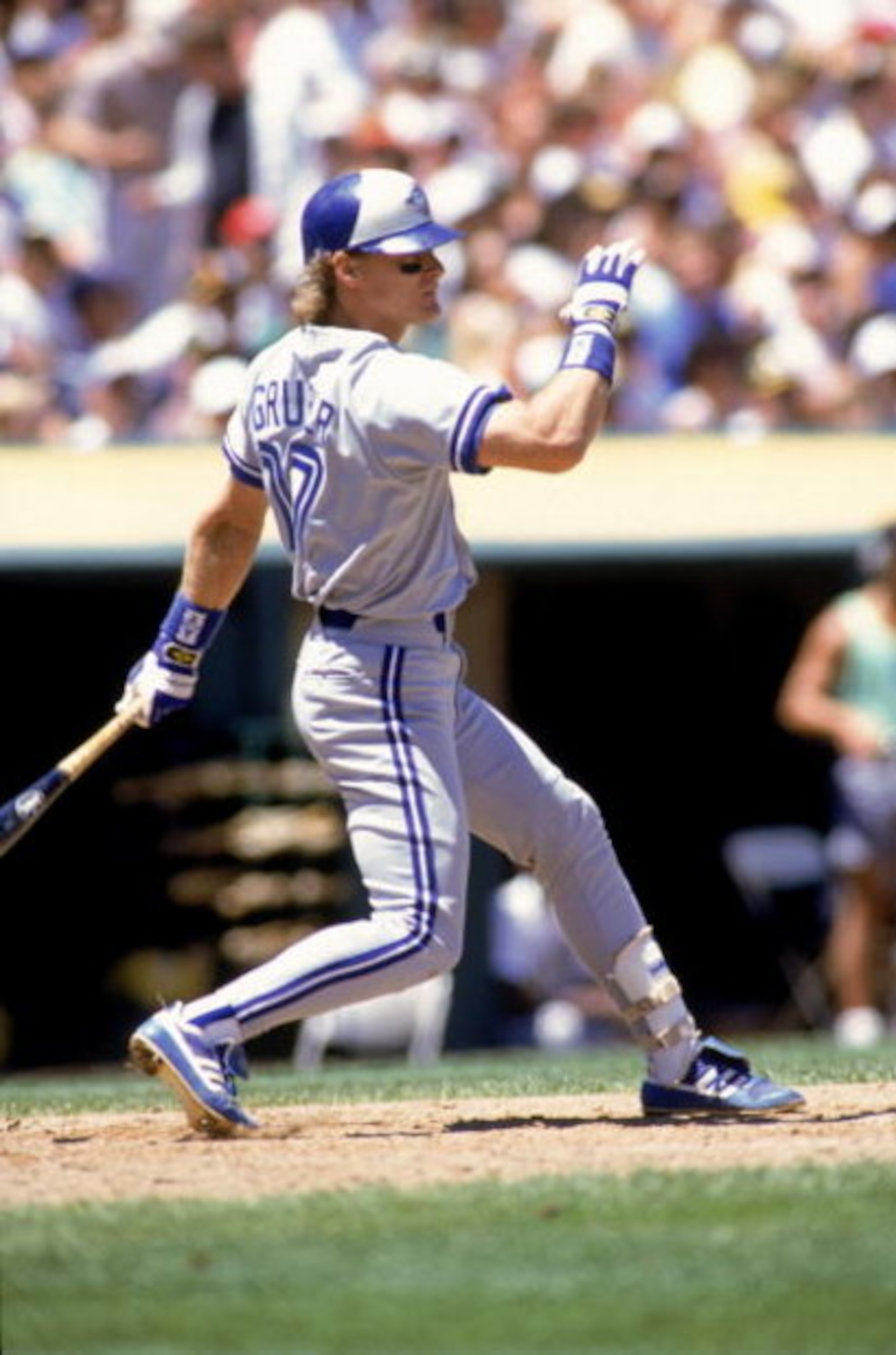OAKLAND, CA - 1990:  Kelly Gruber #17 of the Toronto Blue Jays watches the flight of the ball as he follows through on his swing during a game against the Oakland Athletics in 1990 at Oakland-Alameda County Coliseum in Oakland, California.  (Photo by Otto
