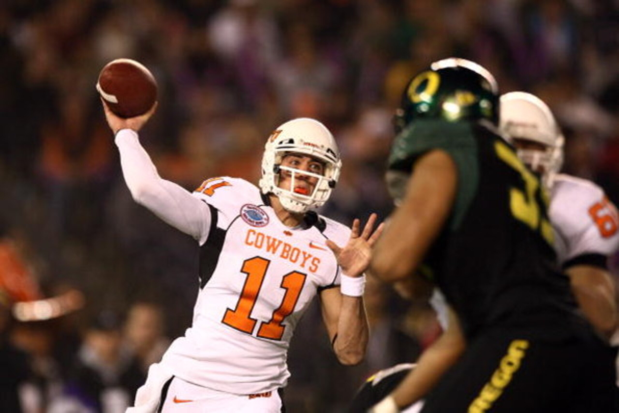 SAN DIEGO, CA - DECEMBER 30:   Quarterback Zac Robinson #11 of the Oklahoma State University Cowboys throws the ball against the University of Oregon Ducks during the Pacific Life Holiday Bowl at Qualcomm Stadium on December 30, 2008 in San Diego, Califor