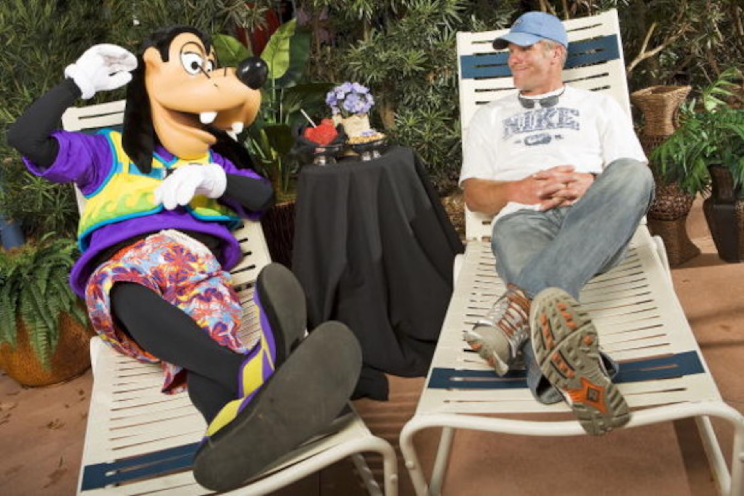 LAKE BUENA VISTA, FL - FEBRUARY 28:  In this handout photo provided by Disney , Brett Favre, who recently announced his retirement, lounges with Goofy on February 28, 2009 at Walt Disney World Resort in Lake Buena Vista, Florida. Favre, who holds multiple