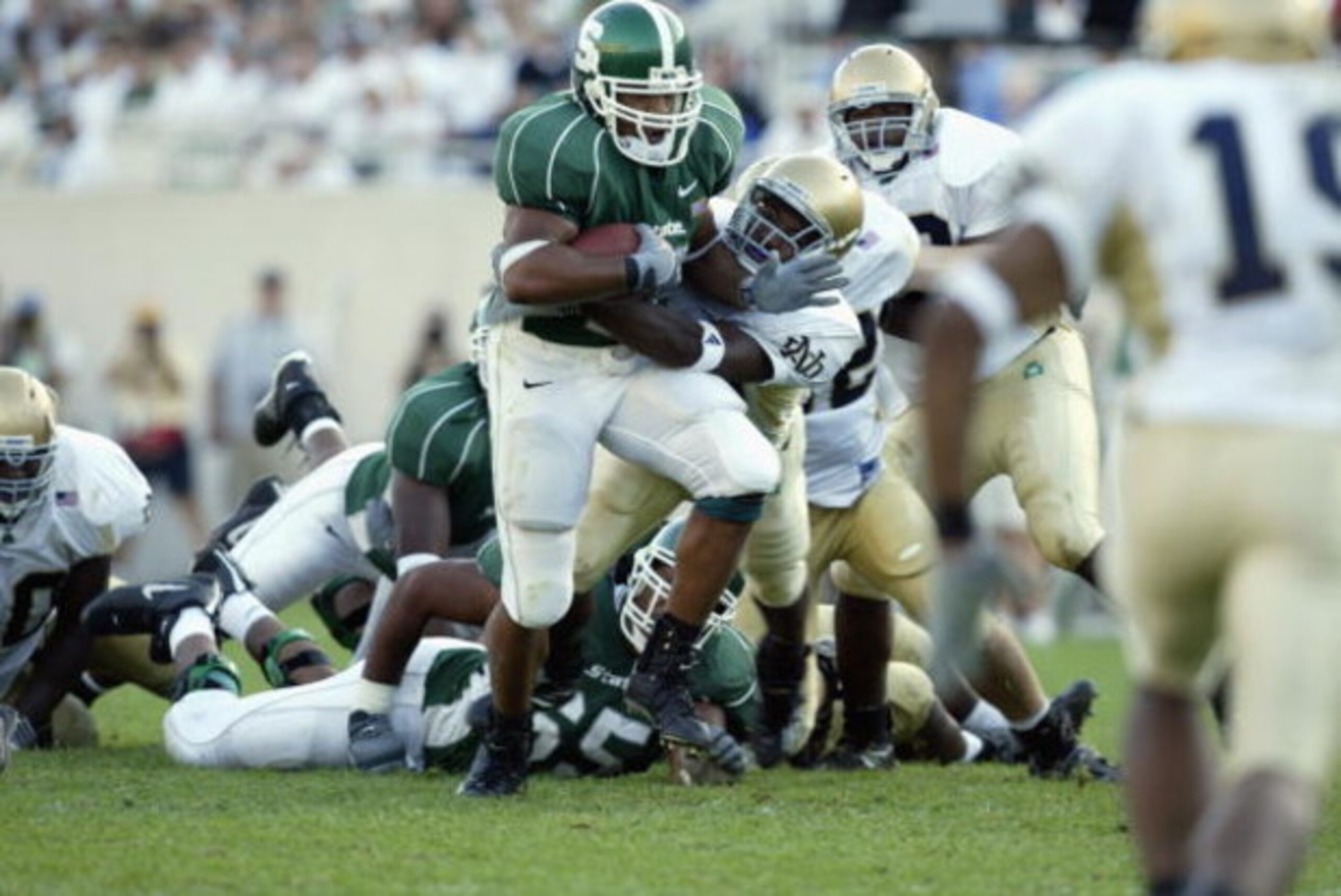 EAST LANSING, MI - SEPTEMBER 21:  Michigan State tailback David Richard #11 breaks out of a Notre Dame tackle during the NCAA football game against Notre Dame at Spartan Stadium in East Lansing, Michigan on September 21, 2002.  The Notre Dame Fighting Iri