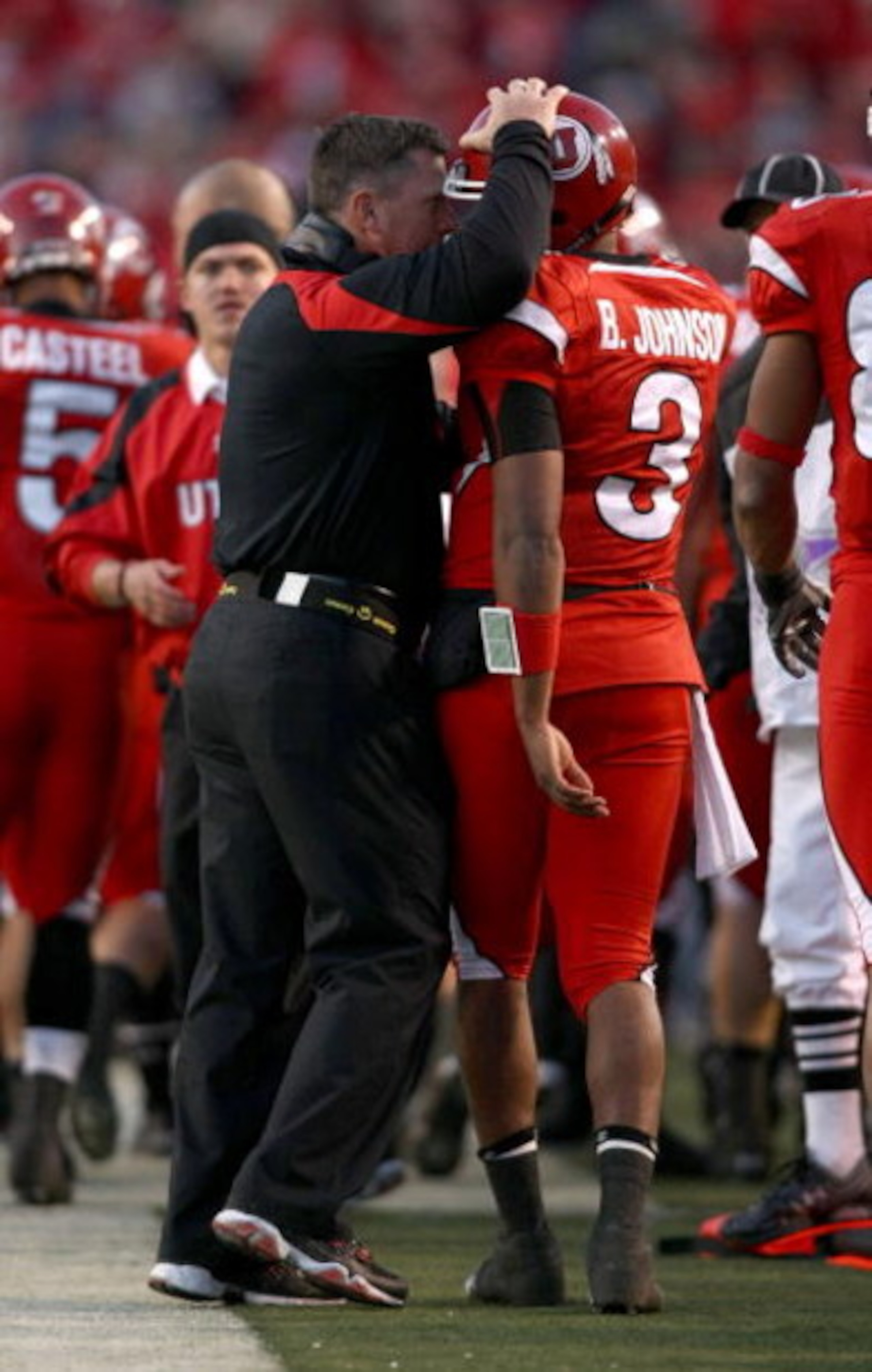 SALT LAKE CITY - NOVEMBER 22:  Head Coach Kyle Whittingham of the Utah Utes talks to quarterback Brian Johnson #3  against the BYU Cougars at Rice-Eccles Stadium on November 22, 2008 in Salt Lake City, Utah.  (Photo by Jonathan Ferrey/Getty Images)