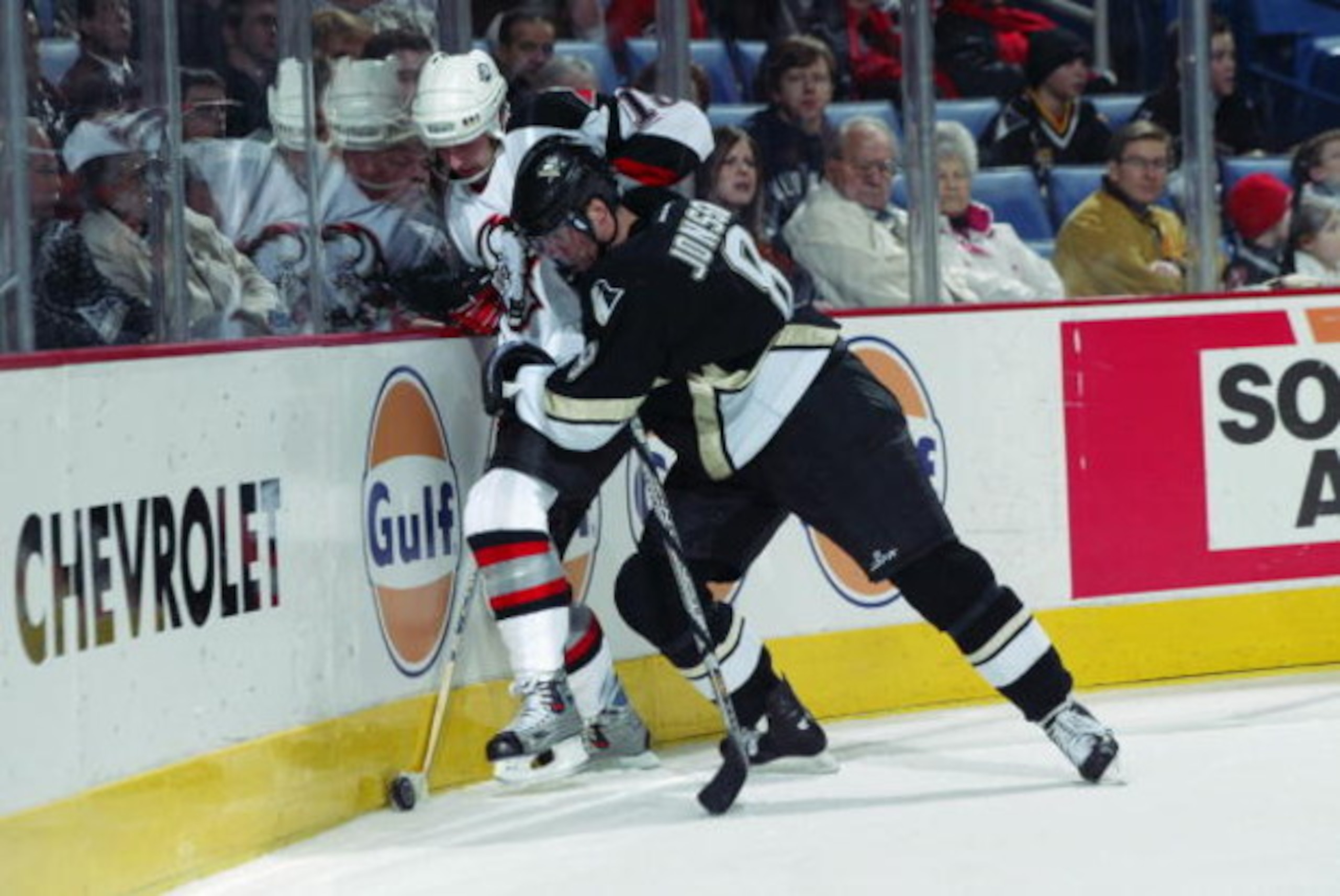 BUFFALO, NY - JANUARY 21:  Hans Jonsson #8 of the Pittsburgh Penguins pins Tim Connolly #18 of the Buffalo Sabres against the boards on January 21, 2002 at HSBC Arena in Buffalo, New York.  The Penguins and Sabres skated to a 0-0 tie.  (Photo by Rick Stew