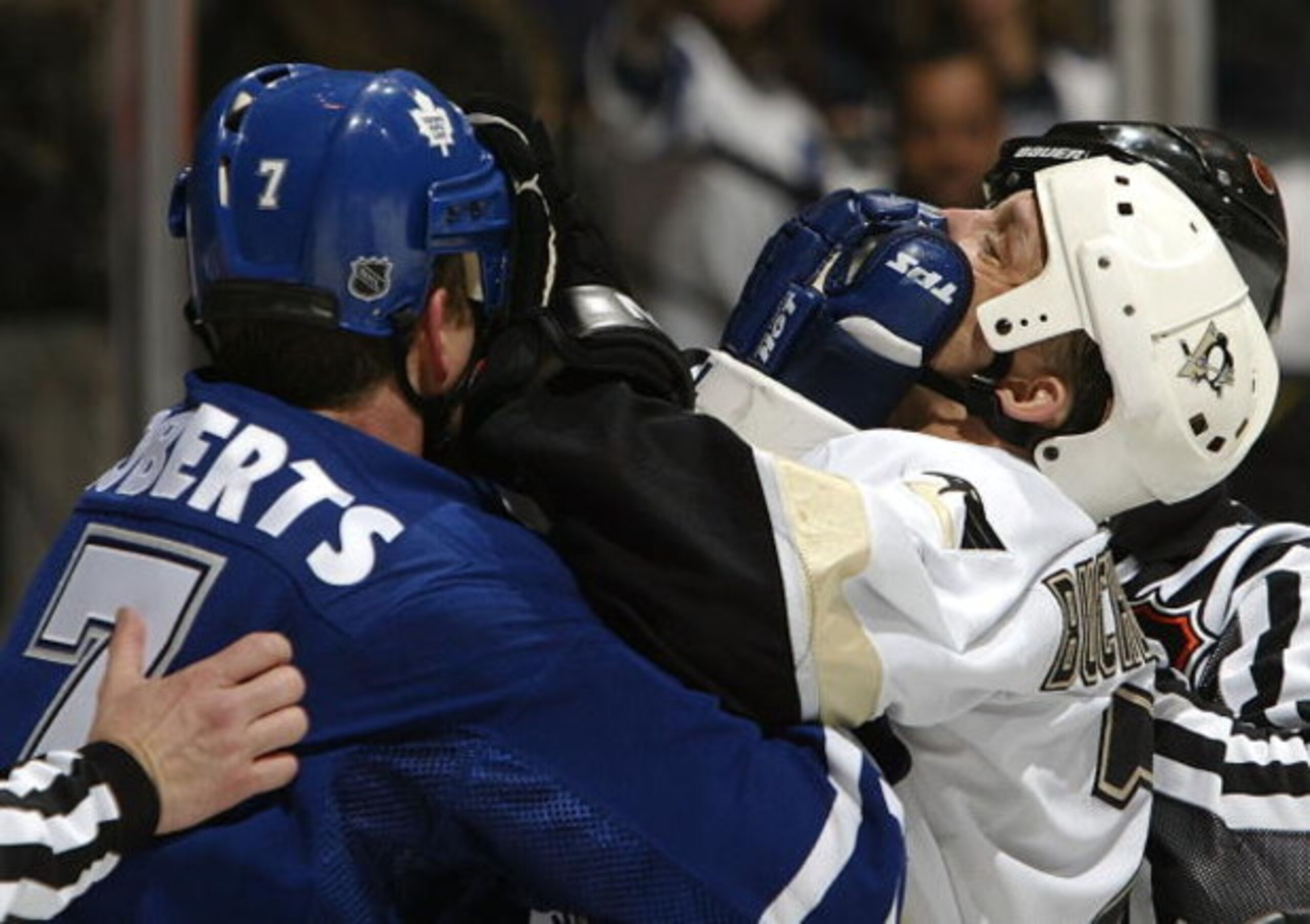 TORONTO - MARCH 11:  Gary Roberts #7 of the Toronto Maple Leafs trades gloves in the face with Kelly Buchberger #7 of the Pittsburgh Penguins March 11, 2004 at Air Canada Centre in Toronto, Ontario, Canada. The Penguins beat the Leafs 3-2.  (Photo By Dave