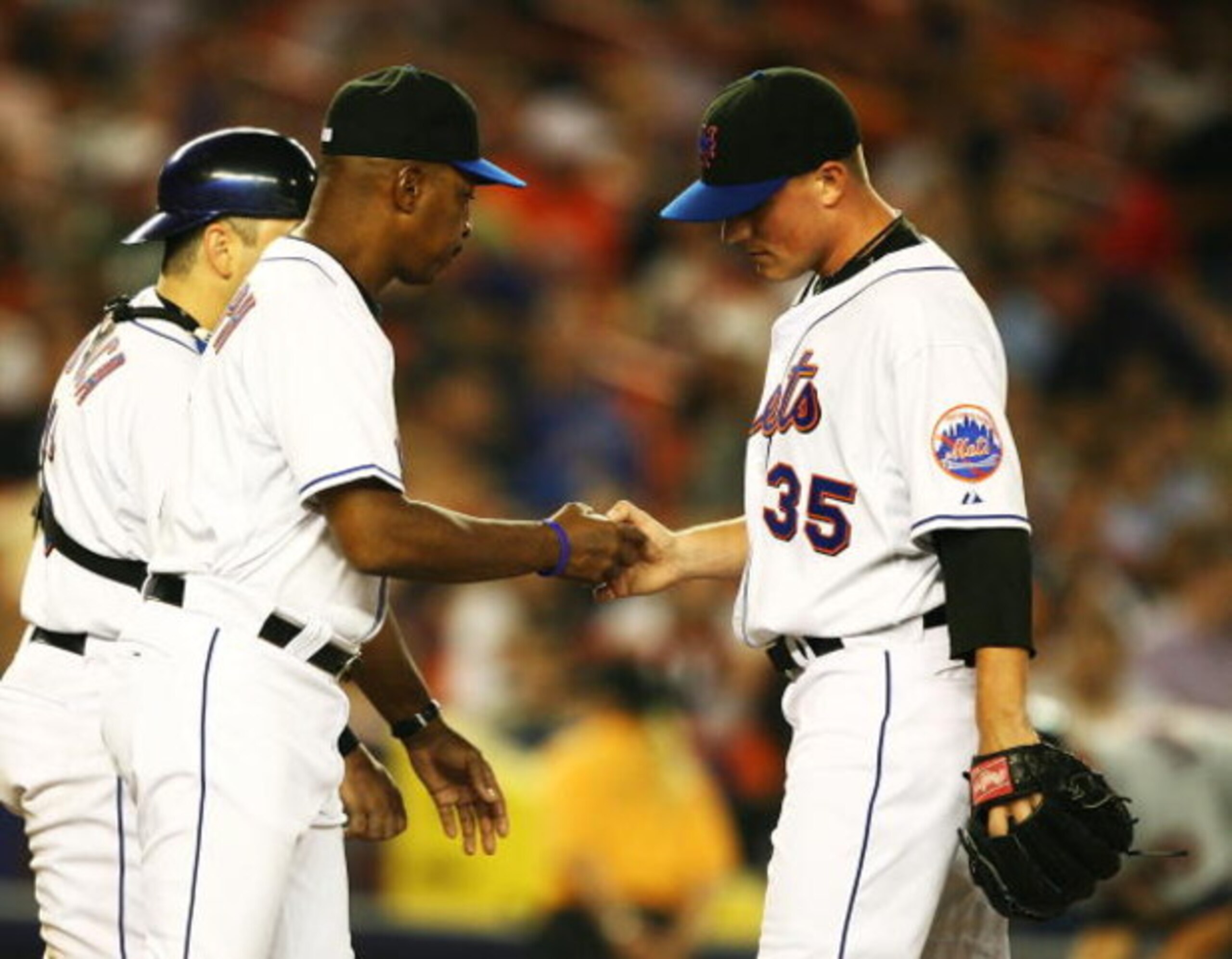NEW YORK - SEPTEMBER 26: Joe Smith #35 of the New York Mets hands the ball to Manager Willie Randolph and leaves the game after giving up two runs in the fifth inning against the Washington Nationals during their game at Shea Stadium on September 26, 200 NEW YORK - SEPTEMBER 26: Joe Smith #35 of the New York Mets hands the ball to Manager Willie Randolph and leaves the game after giving up two runs in the fifth inning against the Washington Nationals during their game at Shea Stadium on September 26, 200