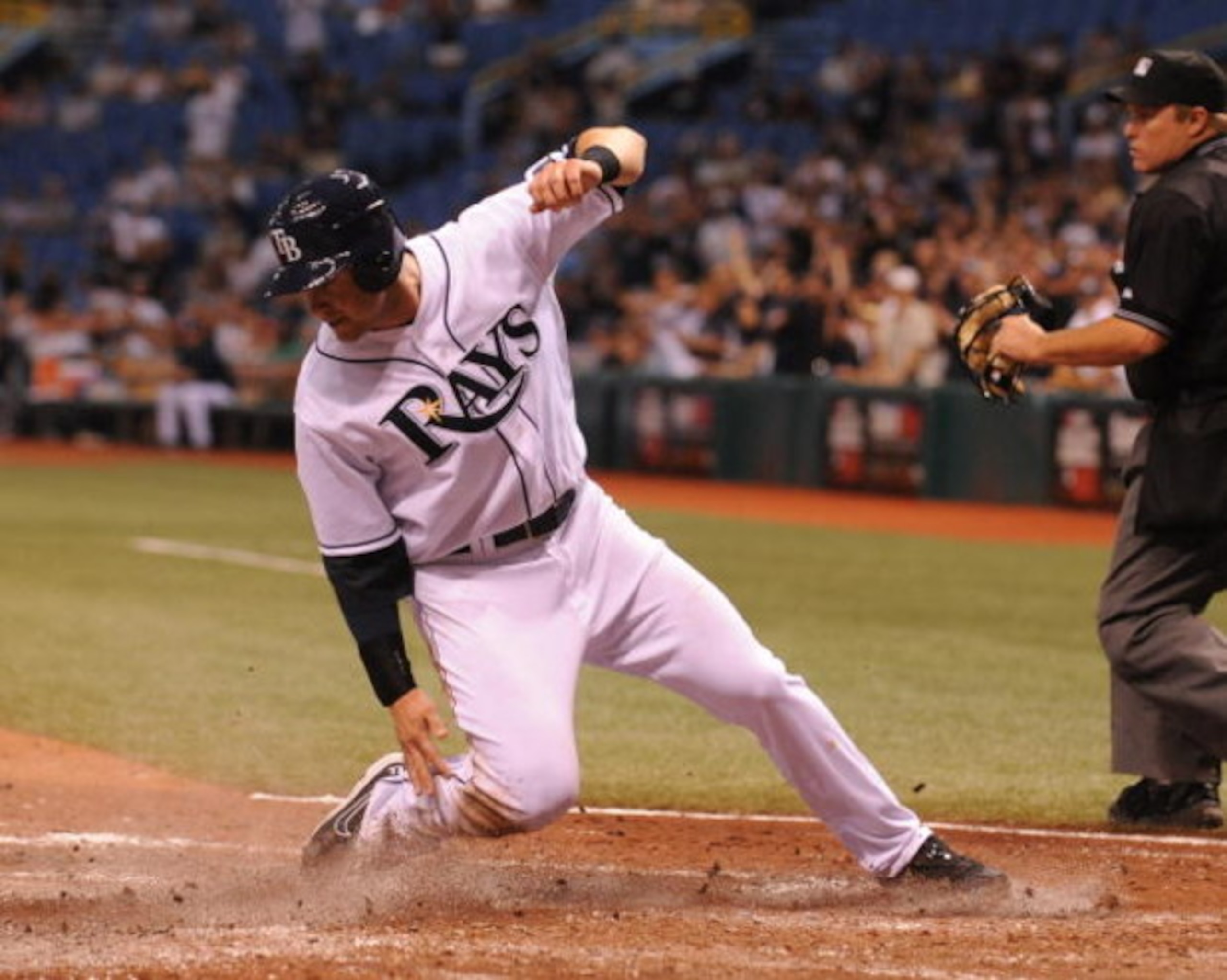 ST. PETERSBURG, FL - APRIL 30: Infielder Evan Longoria #3 of the the Tampa Bay Rays slides into home plate for a run against the Boston Red Sox April 30, 2009 at Tropicana Field in St. Petersburg, Florida.  (Photo by Al Messerschmidt/Getty Images)
