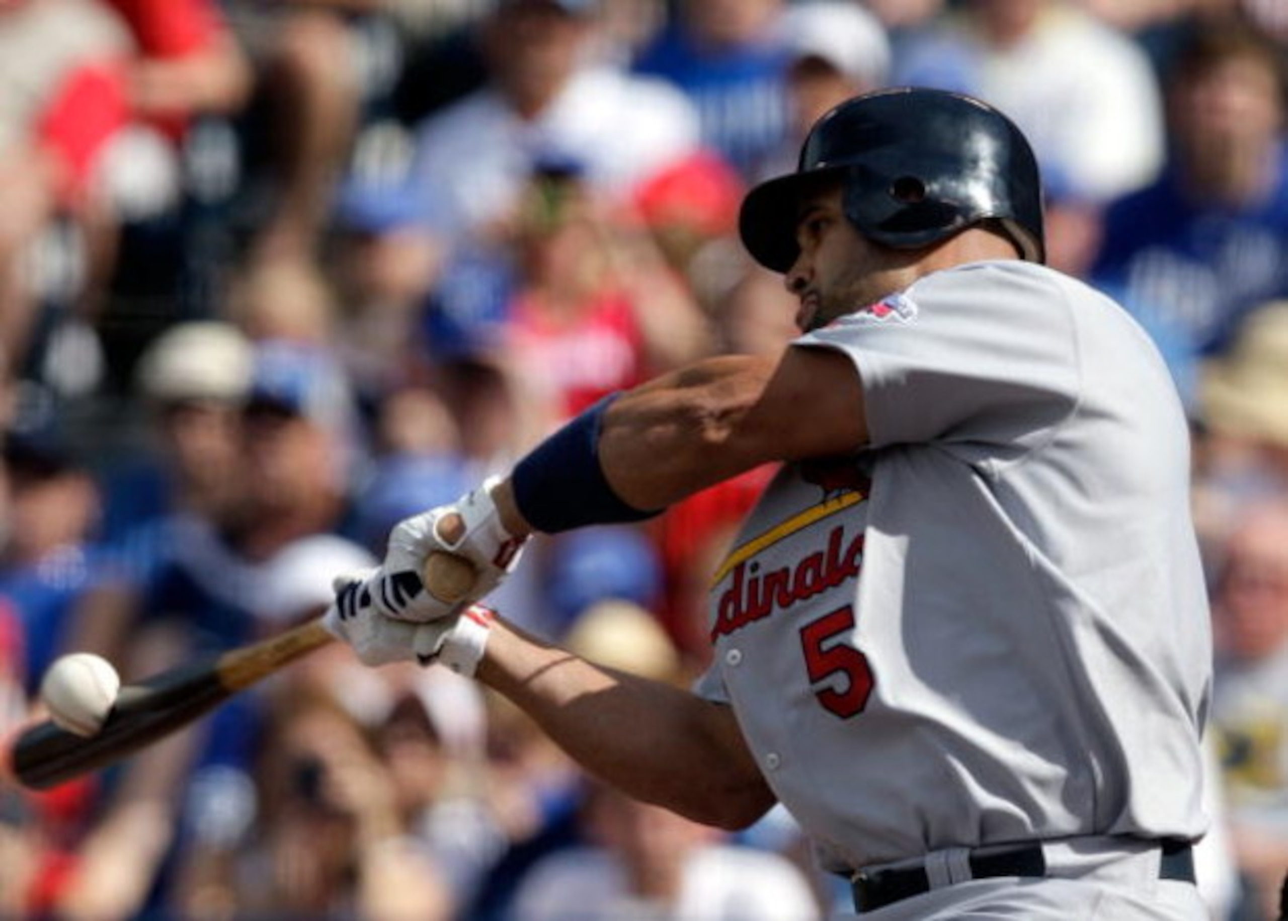 KANSAS CITY, MO - JUNE 20:  Albert Pujols #5 of the St. Louis Cardinals makes contact during the game against the Kansas City Royals on June 20, 2009 at Kauffman Stadium in Kansas City, Missouri.  (Photo by Jamie Squire/Getty Images)