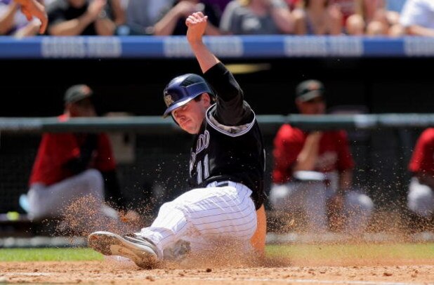 DENVER - MAY 14:  Brad Hawpe #11 of the Colorado Rockies slides home to score against the Houston Astros during MLB action at Coors Field on May 14, 2009 in Denver, Colorado. The Astros defeated the Rockies 5-3.  (Photo by Doug Pensinger/Getty Images)