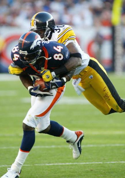 DENVER - OCTOBER 12: Shannon Sharpe #84 tight end for the Denver Broncos runs after a catch while Chad Scott #30 of the Pittsburgh Steelers tries to bring him down on October 12, 2003 at Invesco Field at Mile High in Denver, Colorado. (Photo by Michael Ma