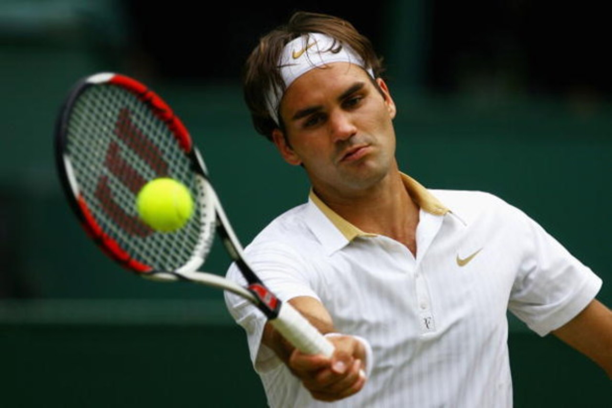 WIMBLEDON, ENGLAND - JUNE 29:  Roger Federer of Switzerland plays a forehand during the men's singles fourth round match against Robin Soderling of Sweden on Day Seven of the Wimbledon Lawn Tennis Championships at the All England Lawn Tennis and Croquet C