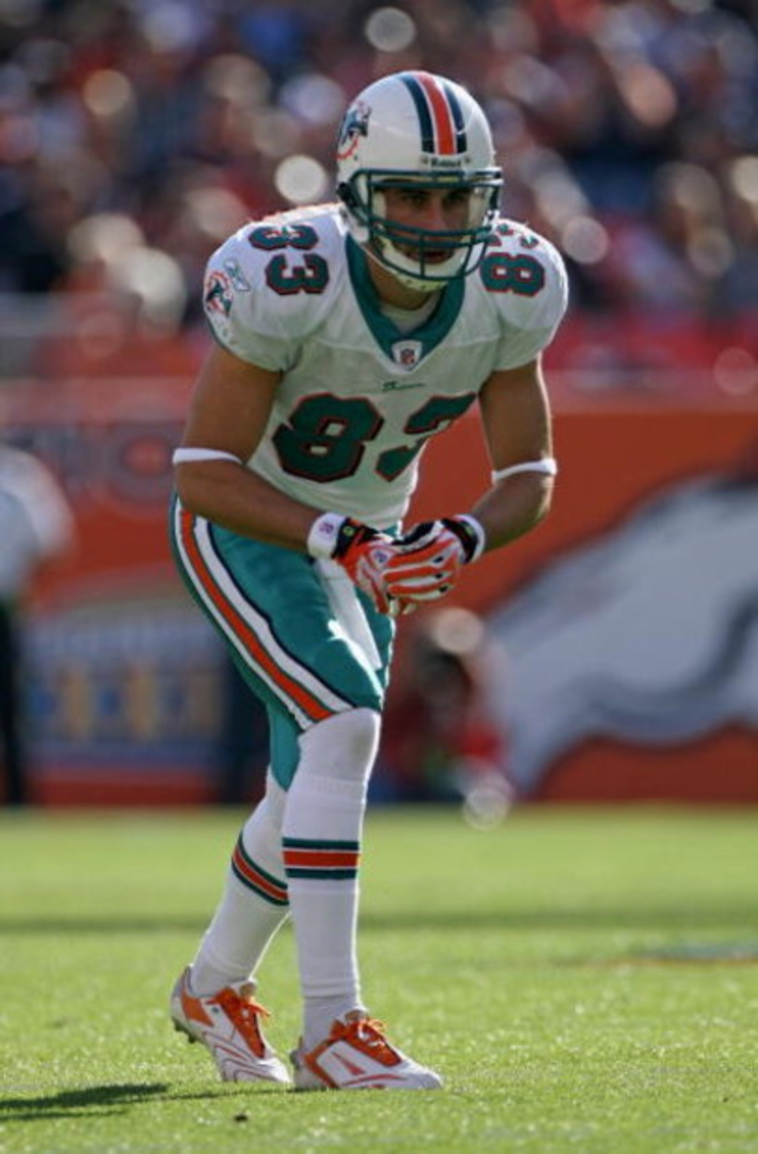 DENVER - NOVEMBER 02:  Wide receiver Greg Camarillo #83 of the Miami Dolphins is poised at the line of scrimmage against the Denver Broncos during NFL action at Invesco Field at Mile High on November 2, 2008 in Denver, Colorado. The Dolphins defeated the 