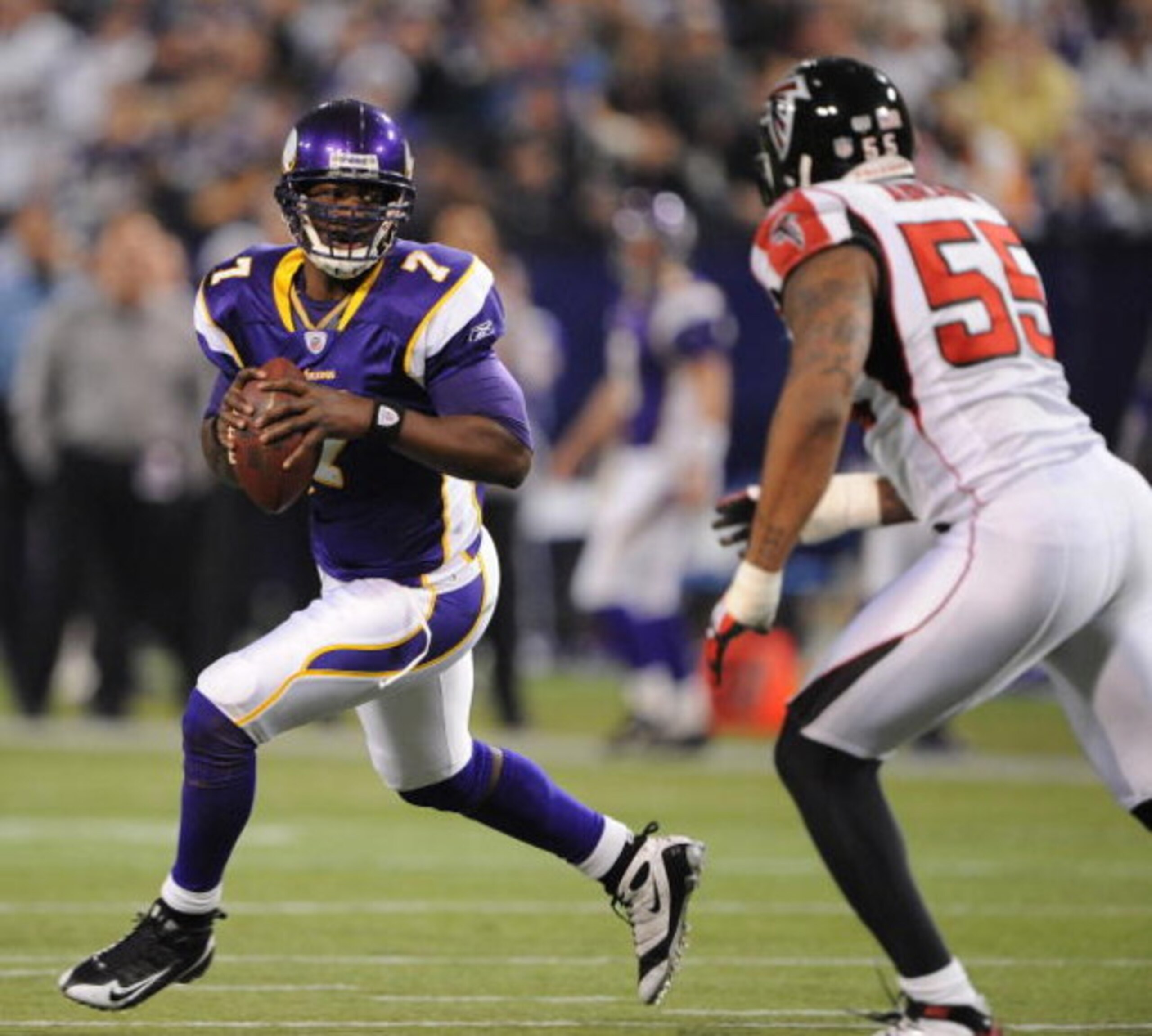 MINNEAPOLIS - DECEMBER 21:  Tarvaris Jackson #7  of the Minnesota Vikings scrambles under pressure from John Abraham #55 of the Atlanta Falcons during an NFL game at the Hubert H. Humphrey Metrodome, on December 21, 2008 in Minneapolis, Minnesota.  (Photo