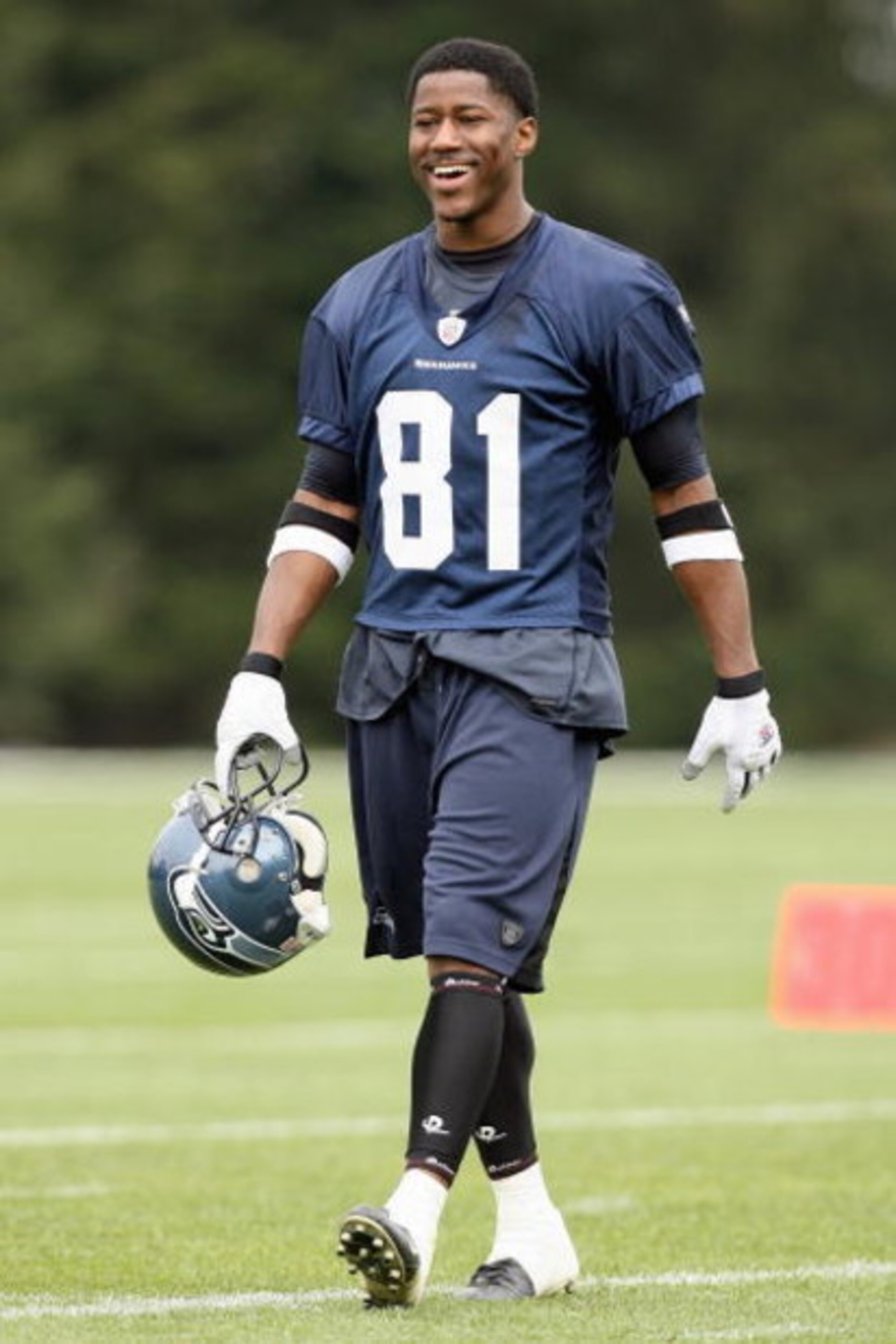 KIRKLAND, WA - MAY 04:  Nate Burleson #81 of the Seattle Seahawks smiles as he walks on the field during mini camp on May 4, 2008 at Seahawks Headquarters in Kirkland, Washington. (Photo by Otto Greule Jr/Getty Images)
