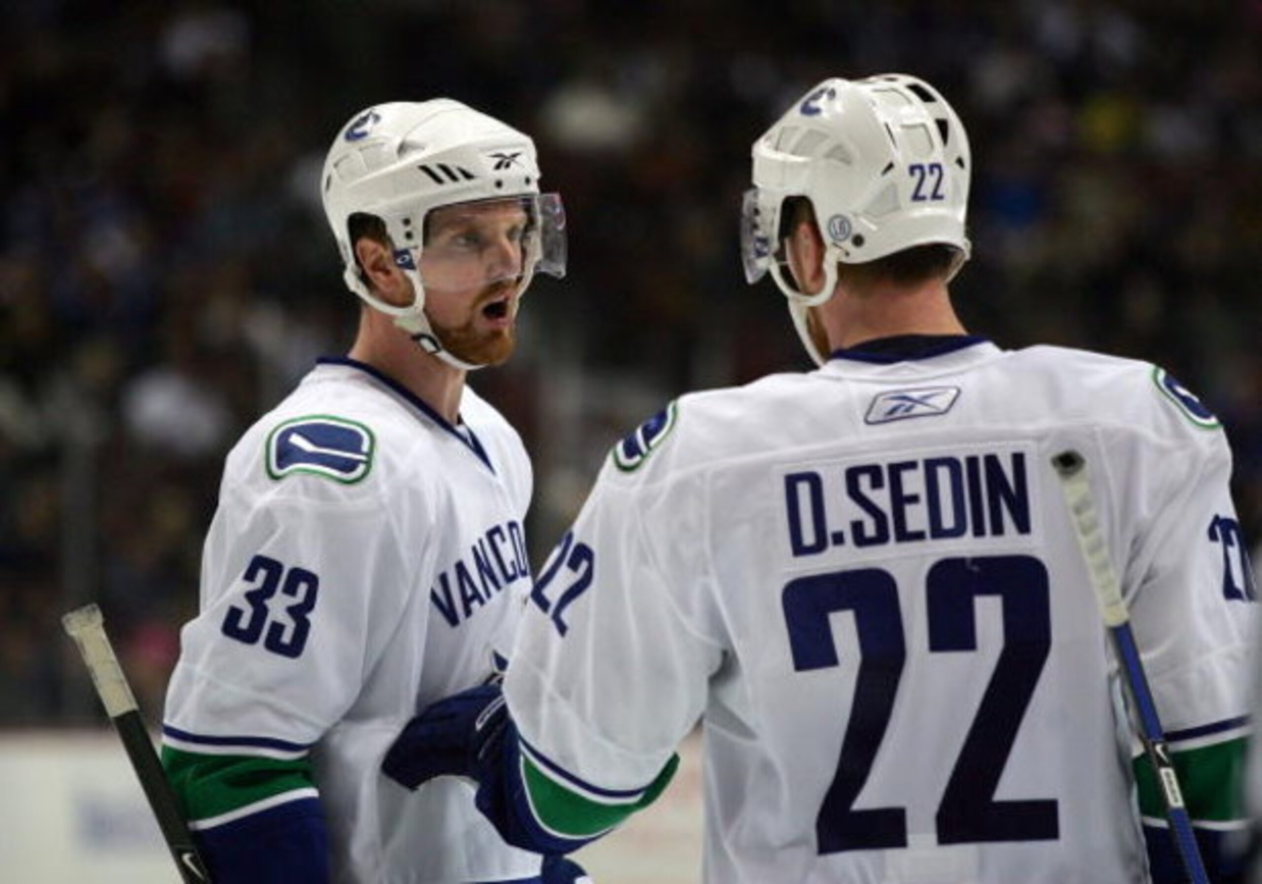 ANAHEIM, CA - MARCH 11:  Henrik Sedin #33 of the Vancouver Canucks has a word with teammate and brother Daniel Sedin #22 during a break in NHL game action against the Anaheim Ducks at Honda Center on March 11, 2009 in Anaheim, California. The Ducks defeat