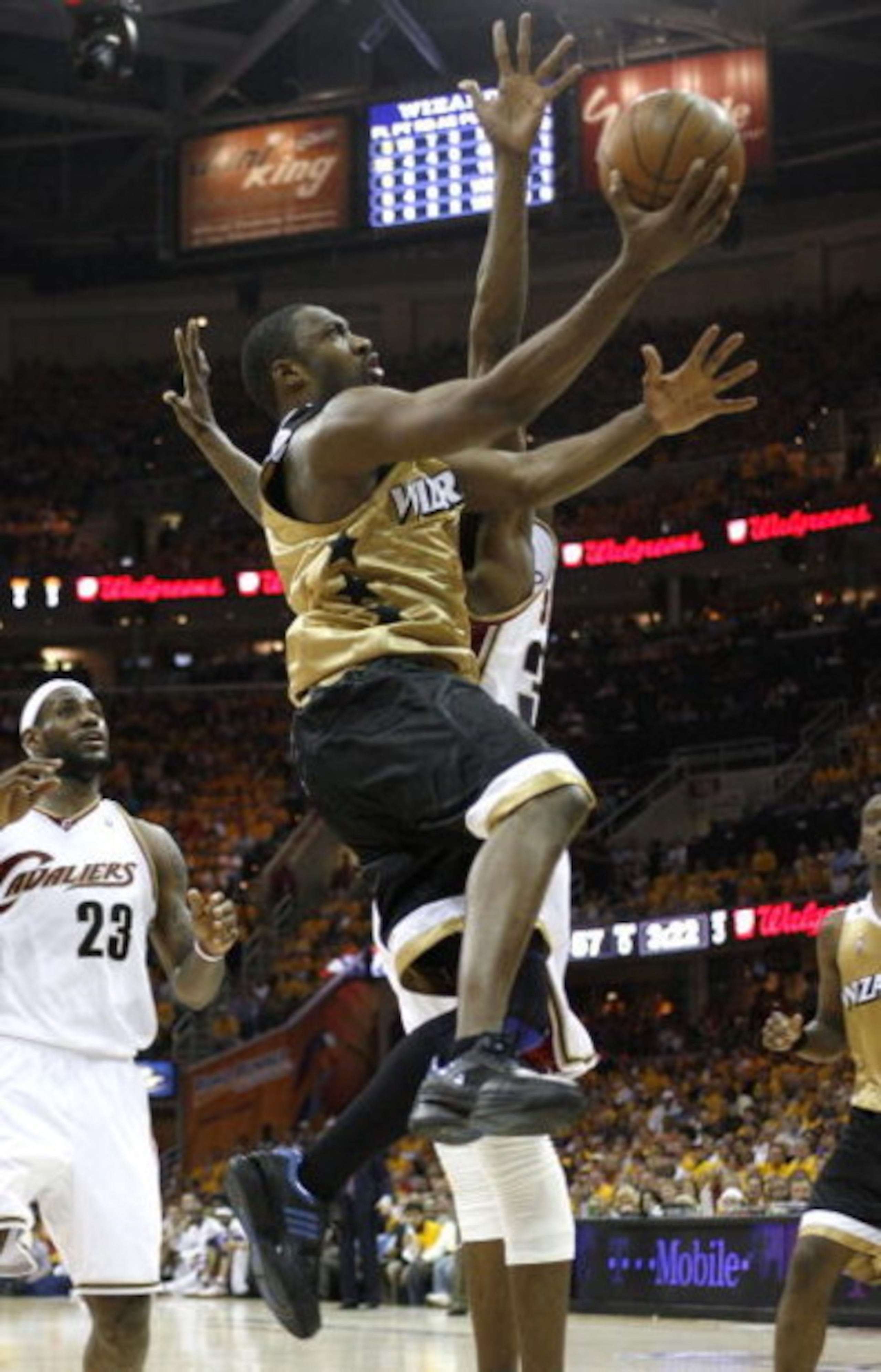 CLEVELAND - APRIL 21:  Gilbert Arenas #0 of the Washington Wizards gets to the basket past Joe Smith #32 and LeBron James #23 of the Cleveland Cavaliers in Game Two of the Eastern Conference Quarterfinals during the 2008 NBA Playoffs at Quicken Loans Aren