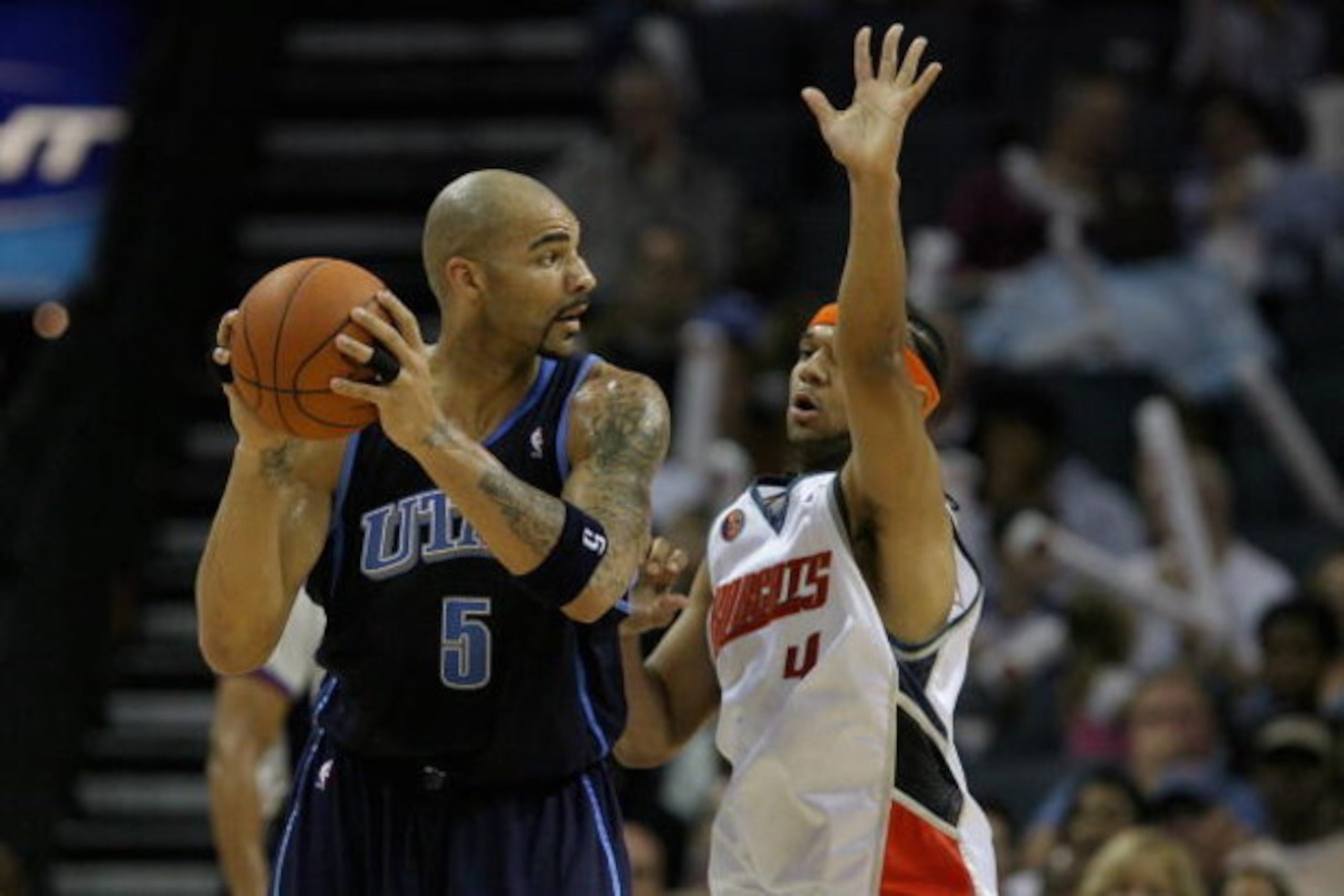 CHARLOTTE, NC - NOVEMBER 14:  Carlos Boozer #5 of the Utah Jazz looks for an open pass over Jared Dudley #4 of the Charlotte Bobcats during the game on November 14, 2008 at Time Warner Cable Arena in Charlotte, North Carolina.  The Bobcats won 104-96.  NO