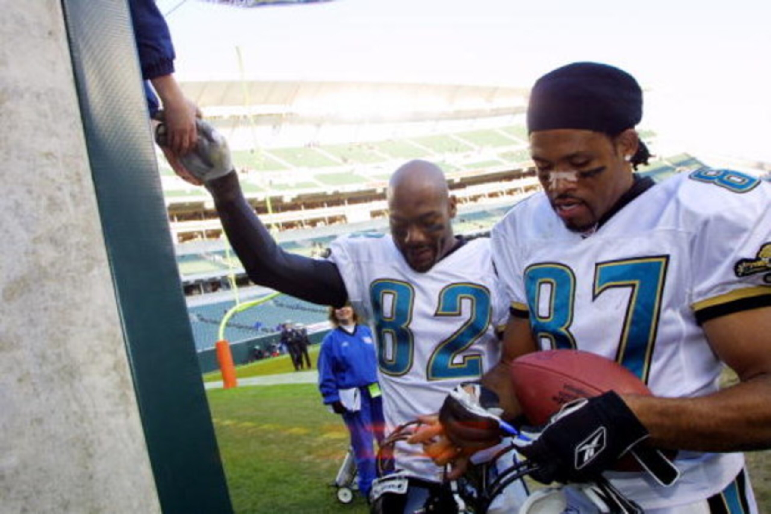 09 Dec 2001 : Keenan McCardell #87 and Jimmy Smith #82 of the Jacksonville Jaguars sign autographs after the game against the Cincinnati Bengals at Paul Brown Stadium in Cincinnati, Ohio. The Jaguars won 14-10. DIGITAL IMAGE. Mandatory Credit : Tom Pidgeo
