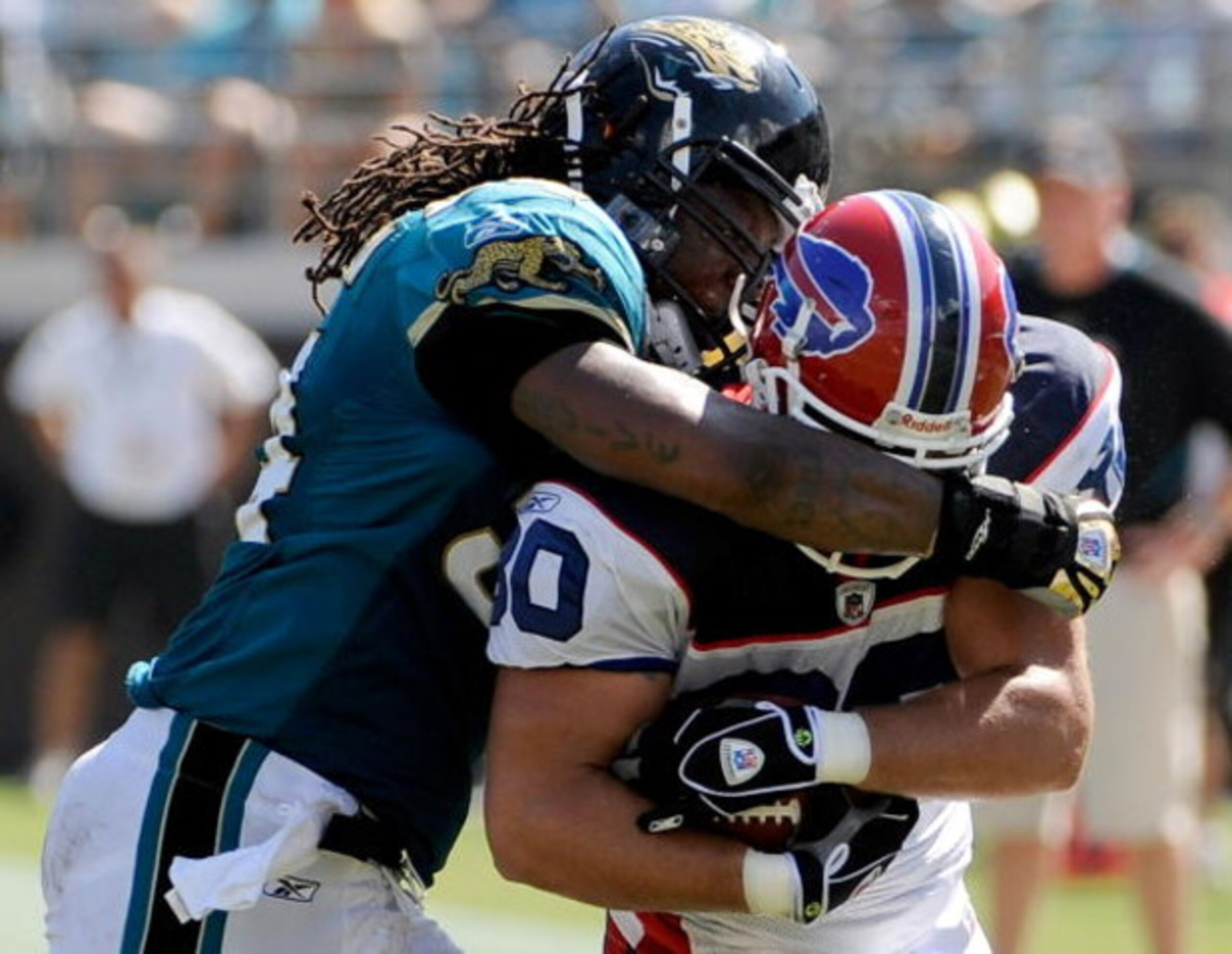 JACKSONVILLE, FL - SEPTEMBER 14:  Derek Schouman #80 of the Buffalo Bills is tackled by Mike Peterson #54 of the Jacksonville Jaguars at Jacksonville Municipal Stadium on September 14, 2008 in Jacksonville, Florida.  (Photo by Sam Greenwood/Getty Images)
