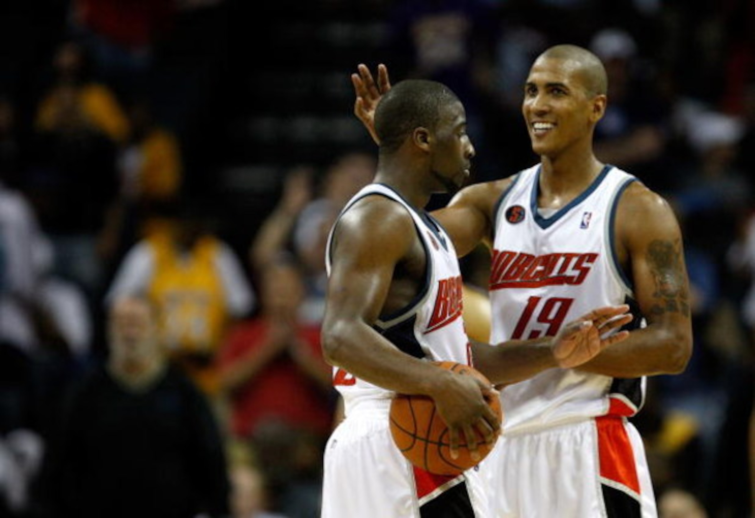 CHARLOTTE, NC - MARCH 31:  Teammates Raja Bell #19 and Raymond Felton #20 of the Charlotte Bobcats react after a play during their game against the Los Angeles Lakers at Time Warner Cable Arena on March 31, 2009 in Charlotte, North Carolina.  NOTE TO USER