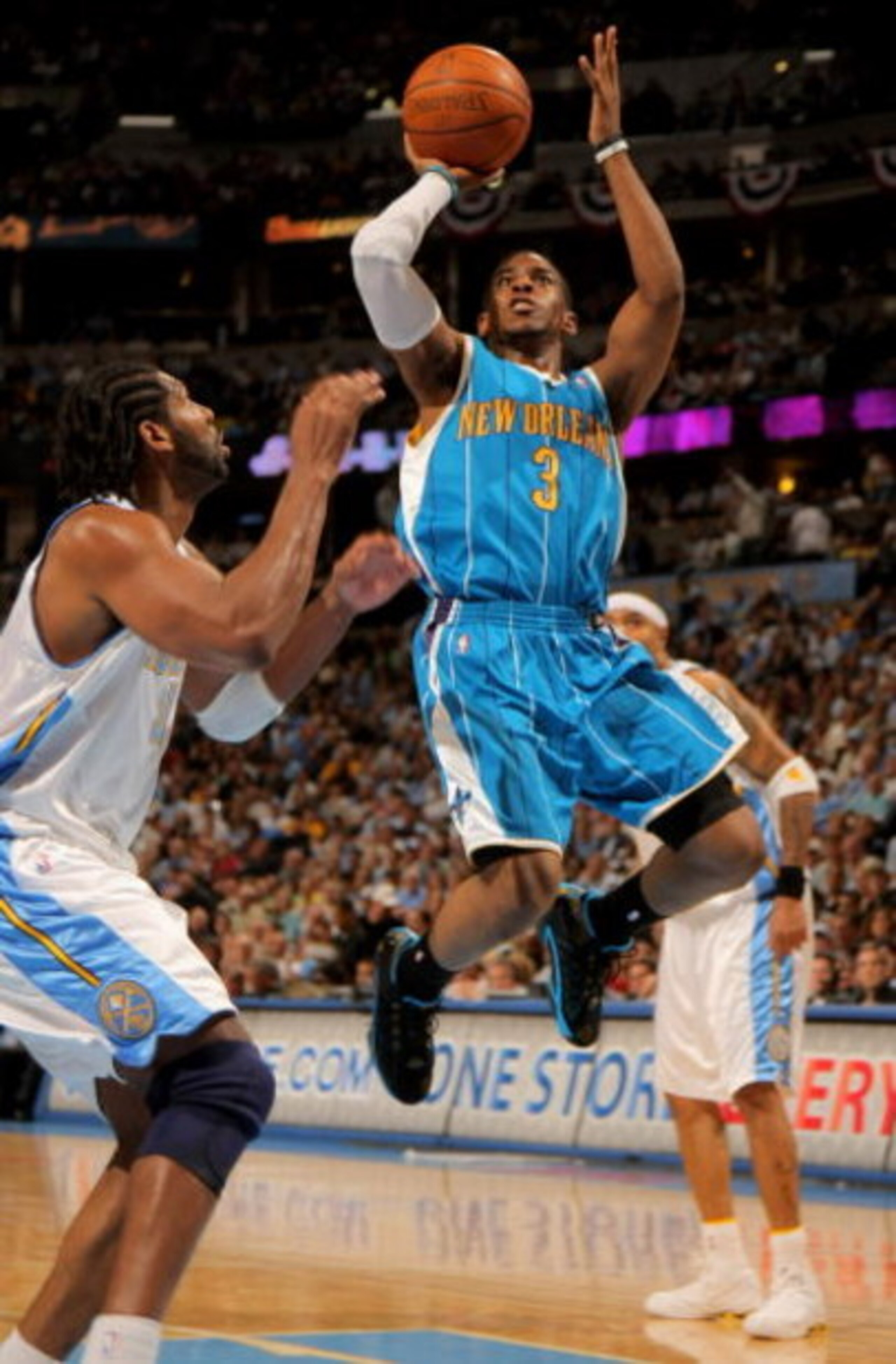 DENVER - APRIL 29:  Chris Paul #3 of the New Orleans Hornets takes a shot Nene #31 of the Denver Nuggets defends in Game Five of the Western Conference Quarterfinals during the 2009 NBA Playoffs at Pepsi Center on April 29, 2009 in Denver, Colorado. The N