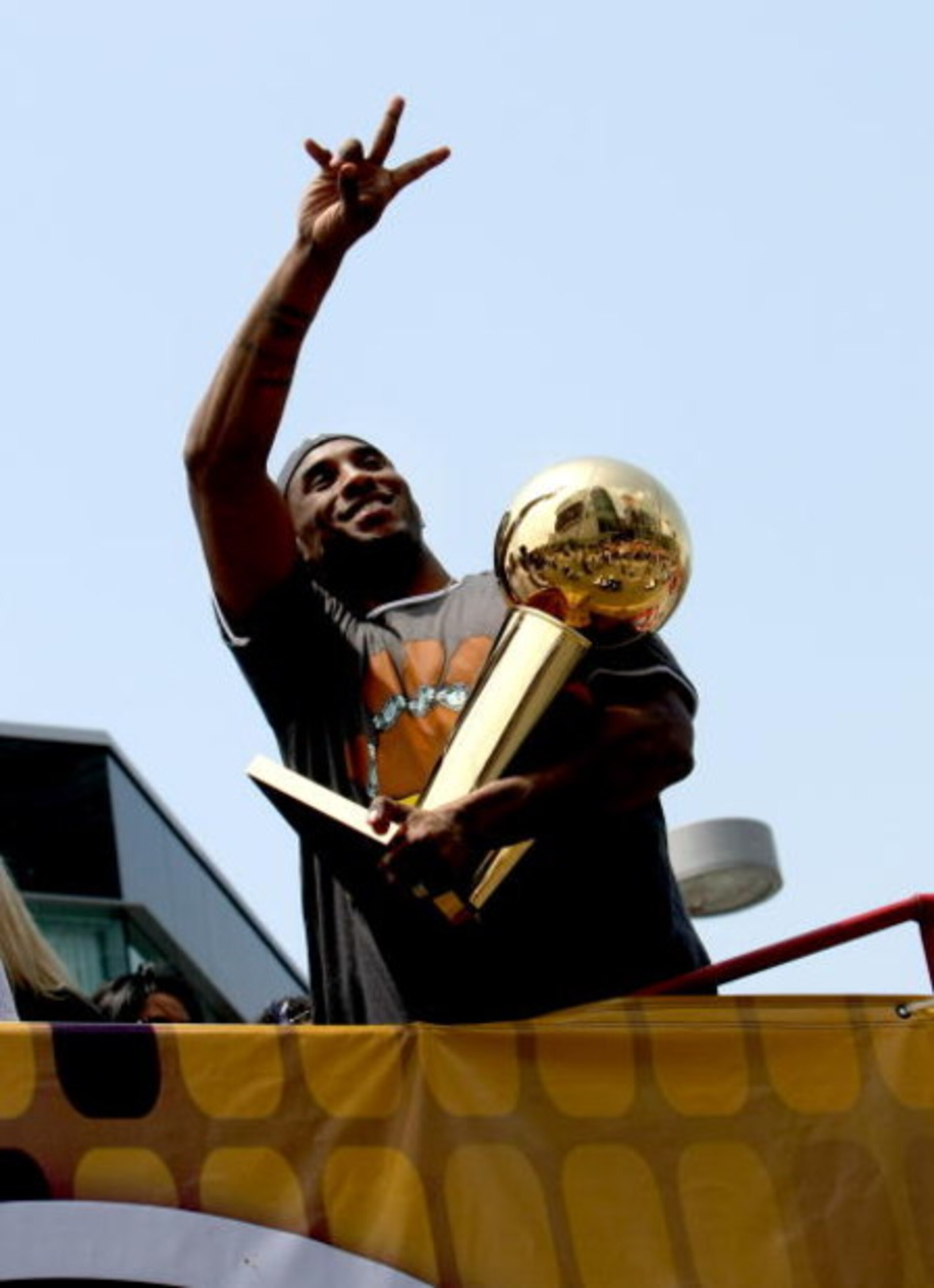 LOS ANGELES, CA - JUNE 17:  Kobe Bryant #24 holds the Larry O'Brien trophy and waves to the crowd from the top of a double decker bus at the start of the Los Angeles Lakers NBA championship victory parade outside the Staples Center on June 17, 2009 in Los