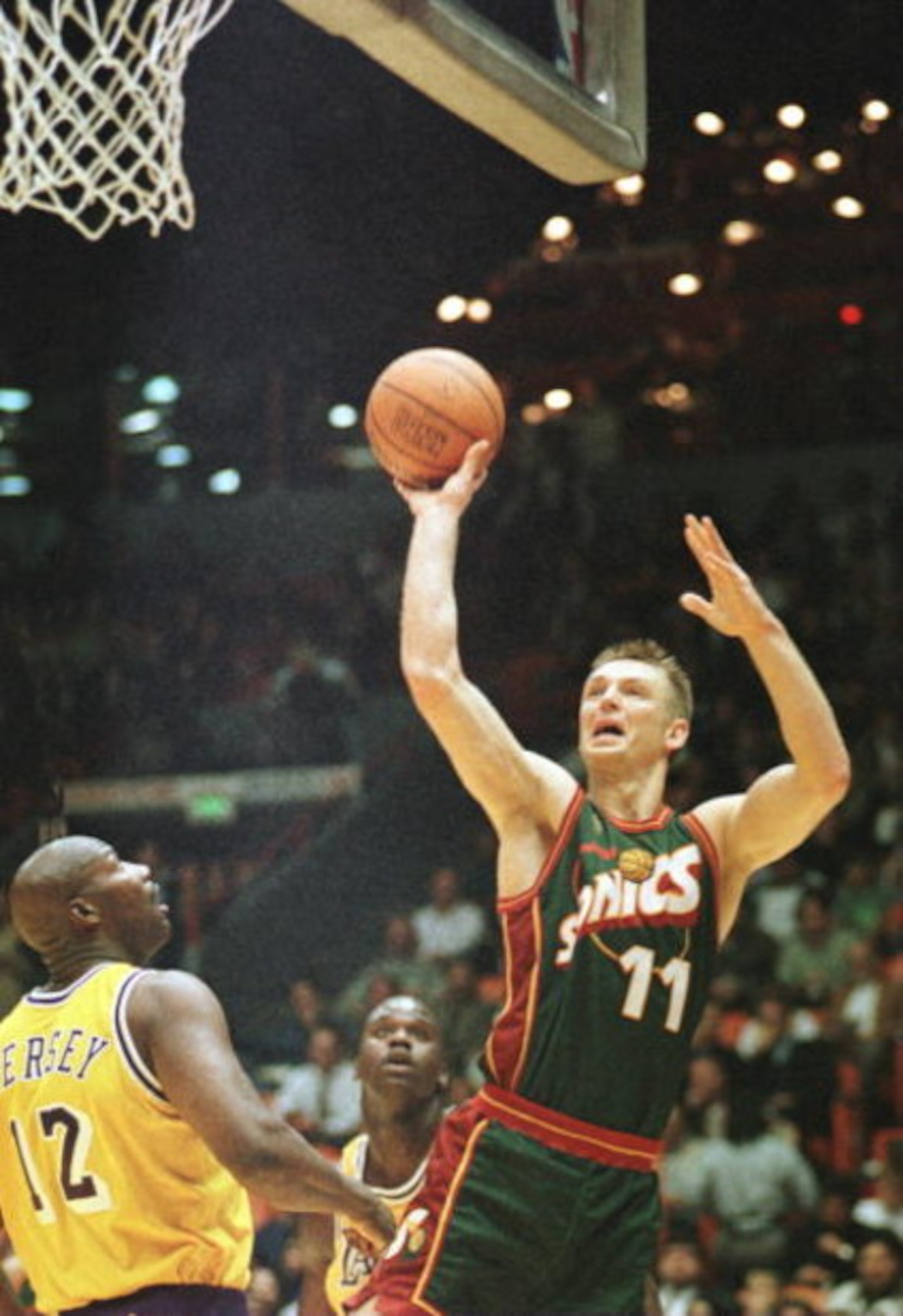 3 Dec 1996:  Detlef Schrempf #11 of the Seattle Supersonics goes up for a shot while Los Angeles Lakers forward Jerome Kersey #12 looks on during the first quarter at the Great Western Forum in Inglewood, California.  Mandatory Credit: Stephen Dunn/Allspo